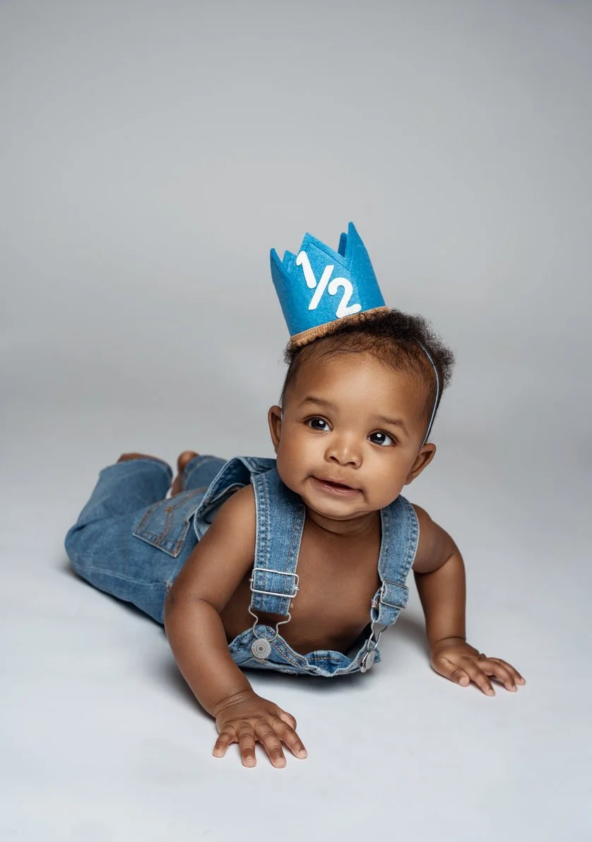 First birthday portrait with baby boy crawling in blue half-birthday crown in Chicago - Filaneyka photo studio