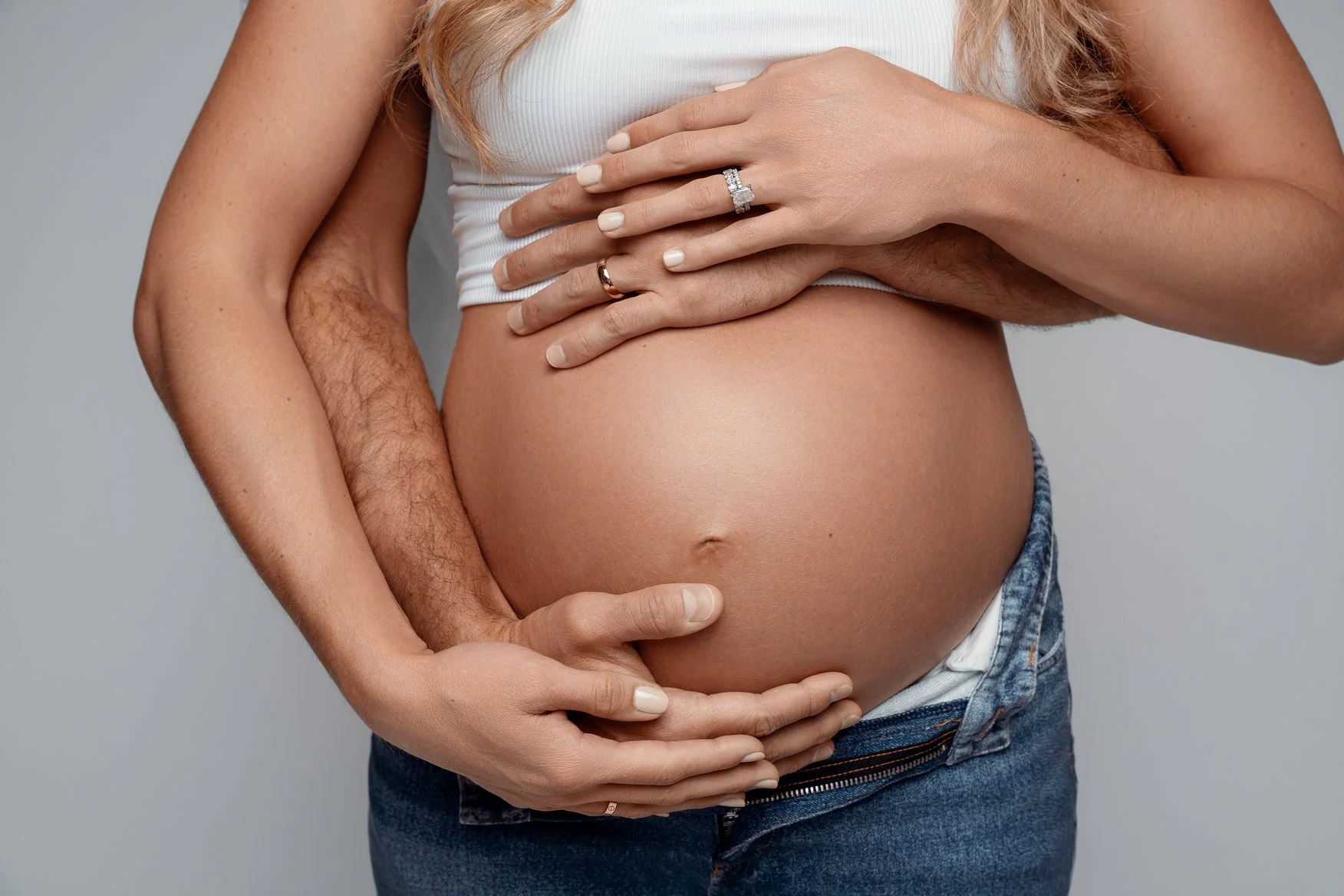 Pregnancy photography with hands embracing bare bump in Chicago - Filaneyka photo studio