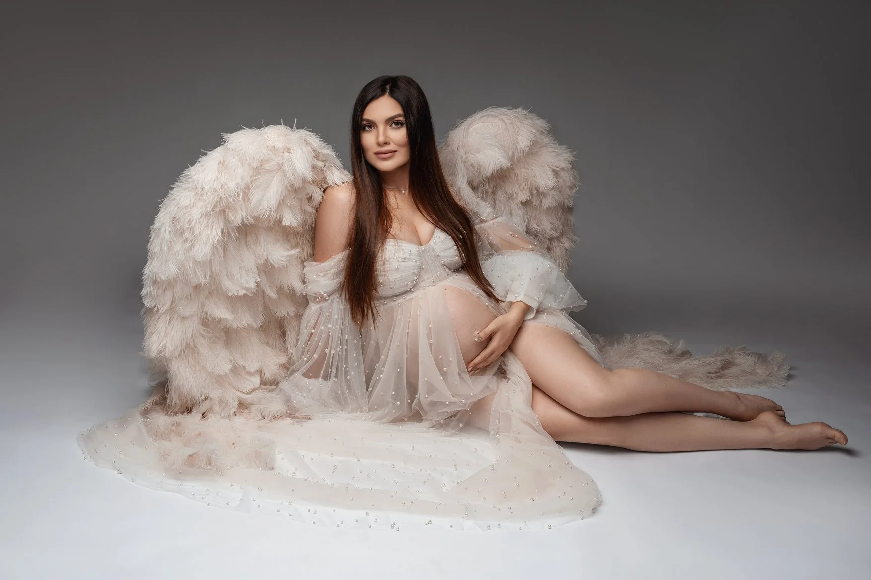Expecting mother photoshoot with pregnant angel wings seated pose in Chicago - Filaneyka photo studio