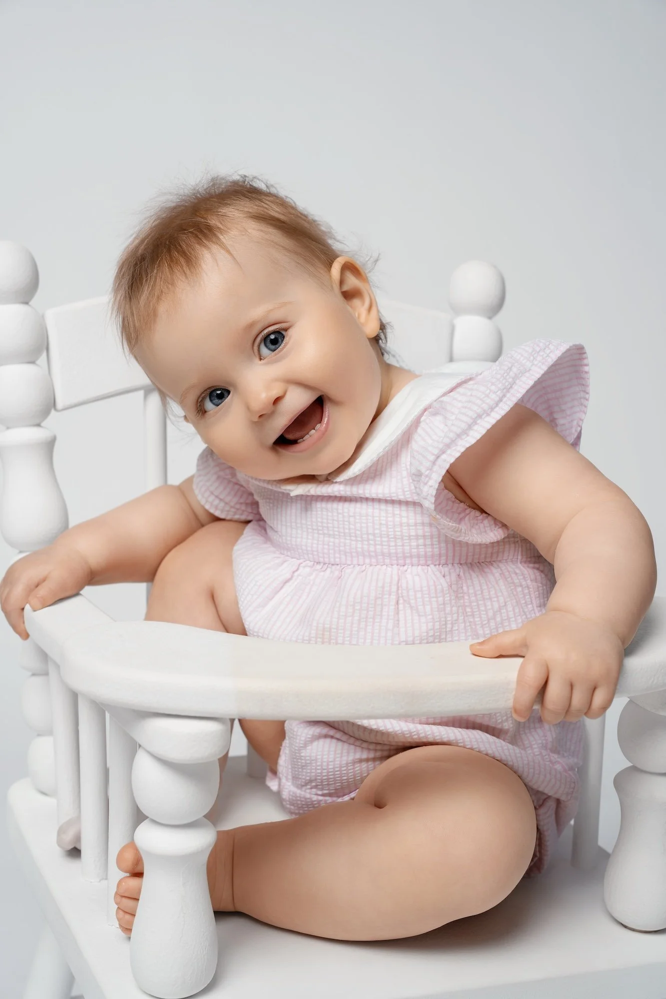 Fine-art first birthday photoshoot: smiling baby girl