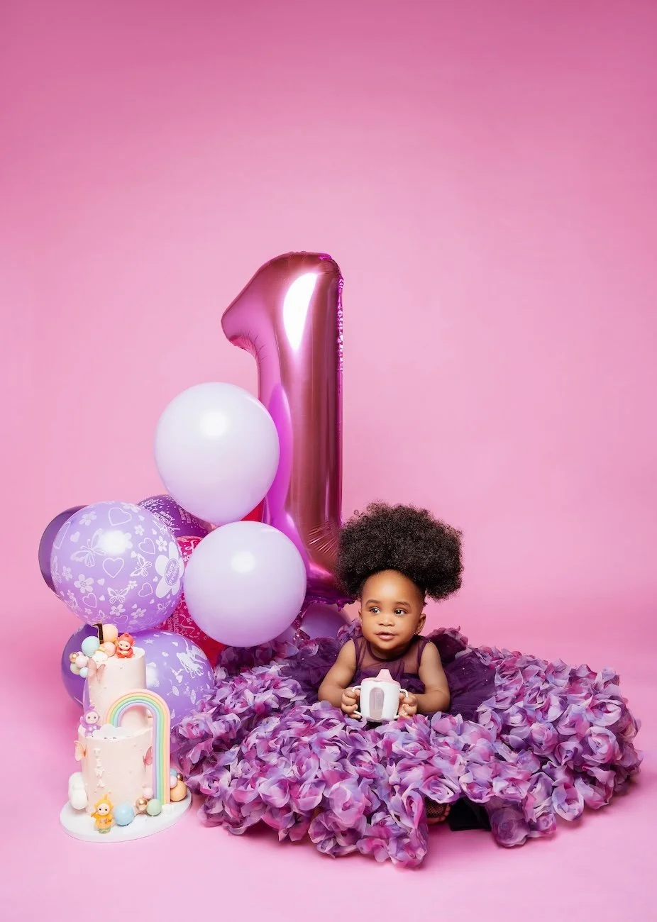 First birthday photoshoot with baby girl in purple dress with balloons in Chicago - Filaneyka photo studio