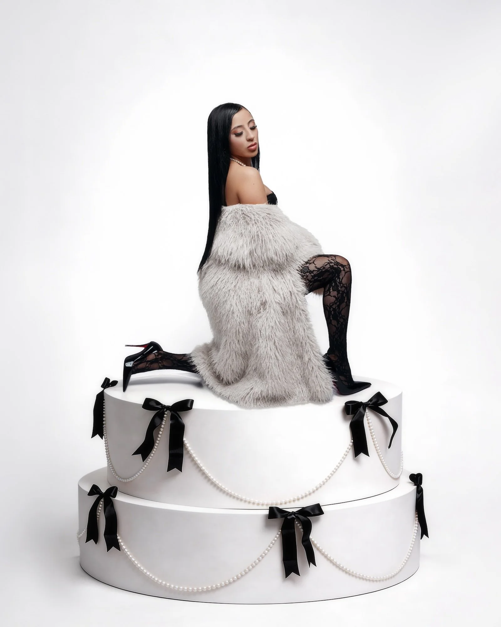 Luxury birthday photoshoot: woman celebrating in a boutique-style studio portrait with glamorous styling