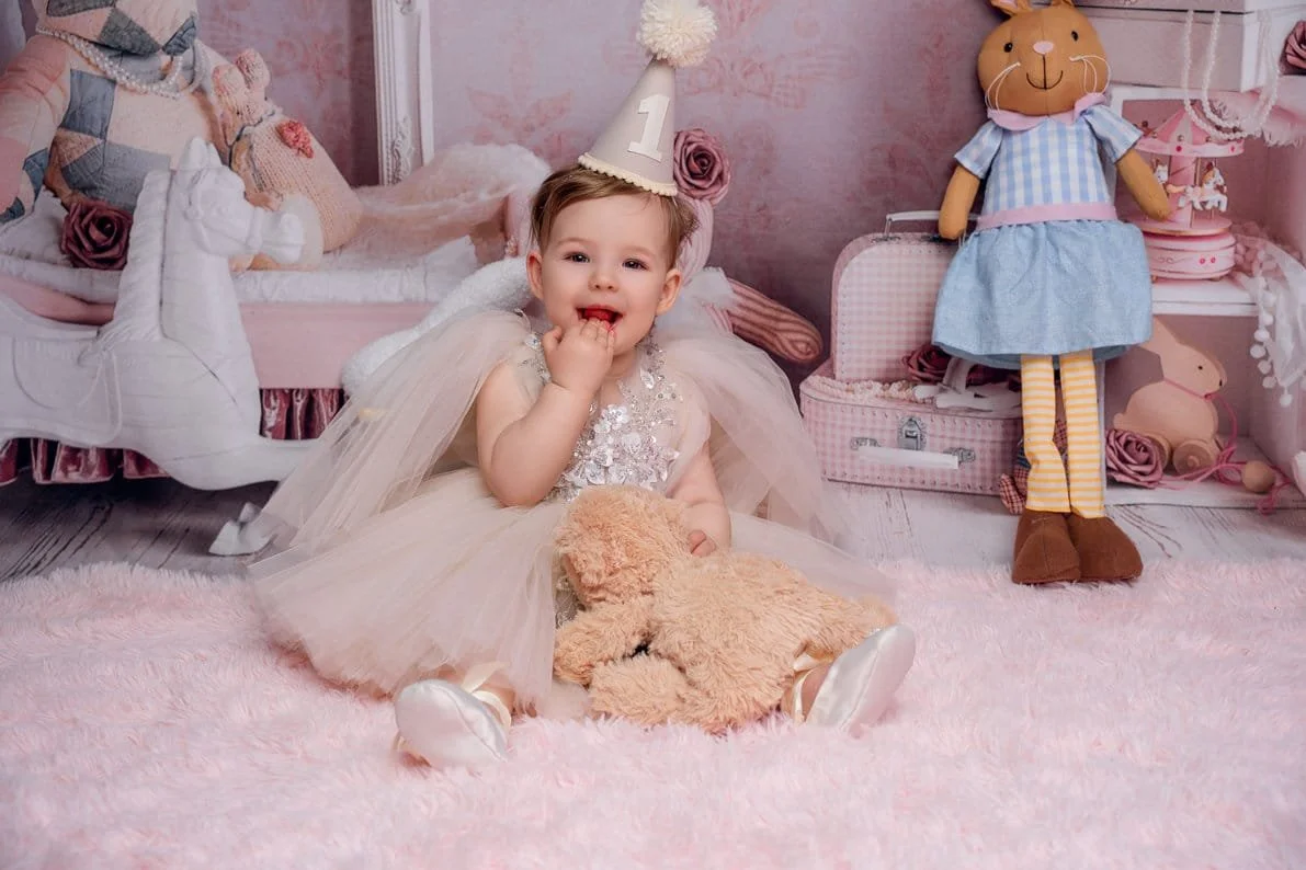 First birthday photoshoot with toddler with teddy and party hat in Chicago - Filaneyka photo studio
