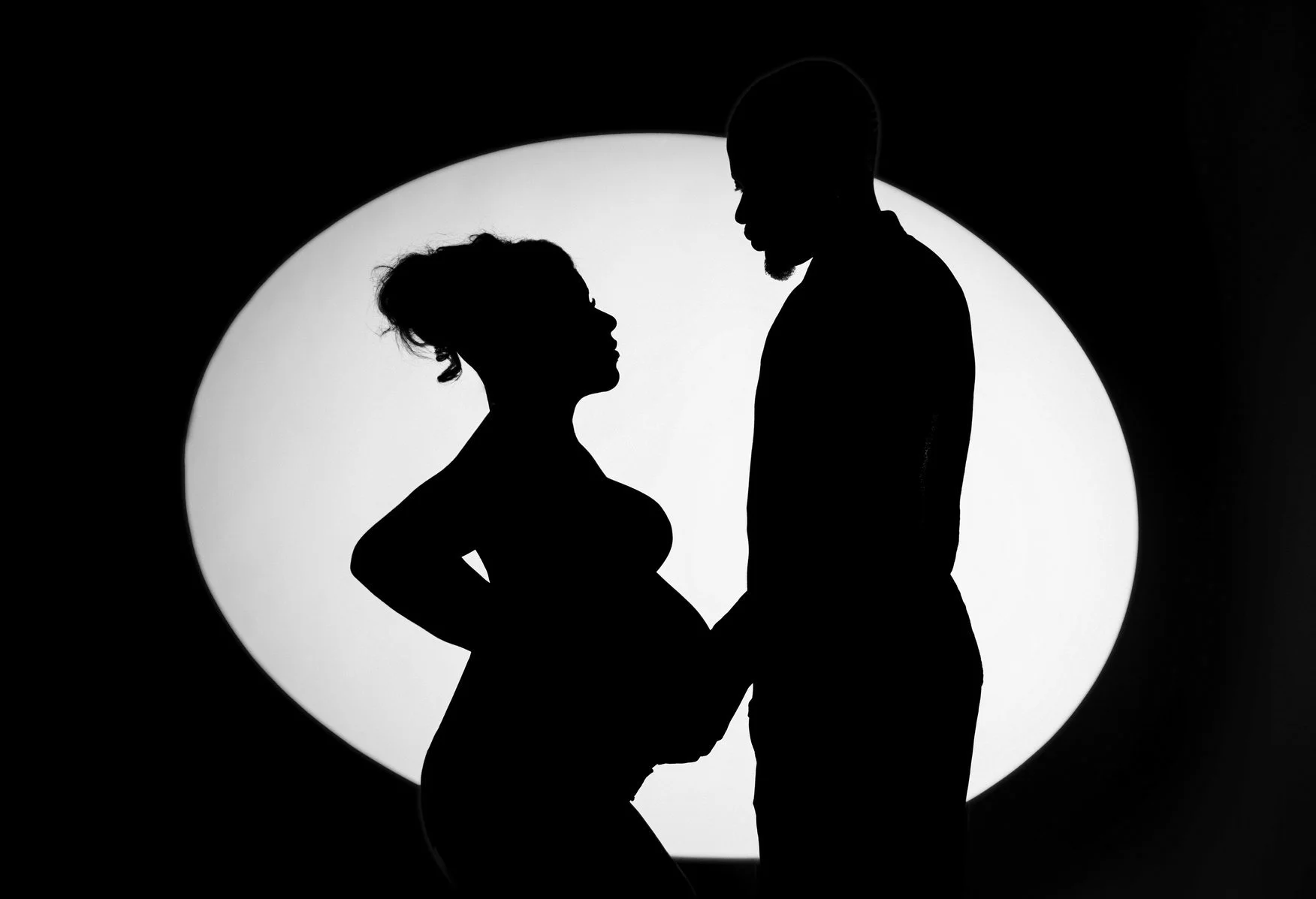 Prenatal photography session with pregnant couple silhouette spotlight in Chicago - Filaneyka photo studio