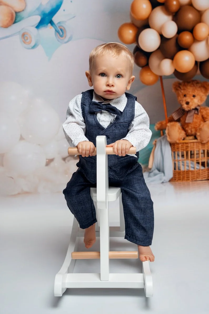 First birthday portrait with toddler on rocking horse with balloons in Chicago - Filaneyka photo studio