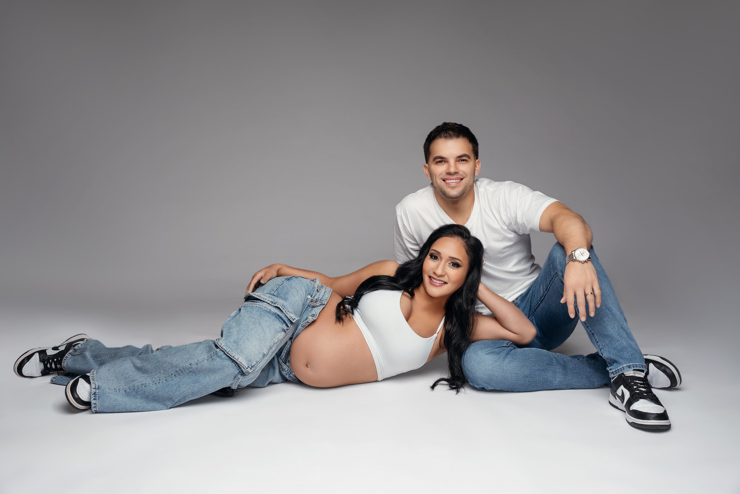 Classic maternity session: casual couple in jeans in a relaxed studio setting