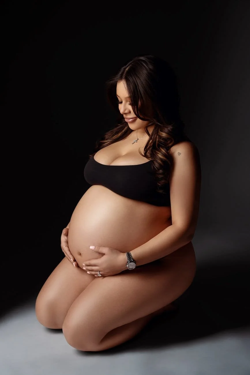 Pregnancy photography with kneeling intimate dark maternity portrait in Chicago - Filaneyka photo studio