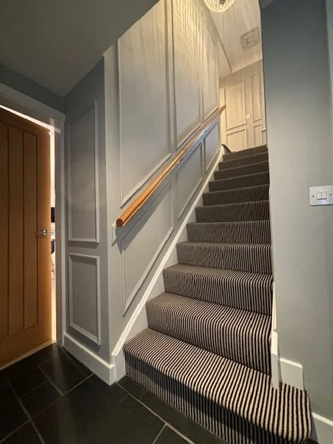 Double height beaded panelling on hall stairs and landing