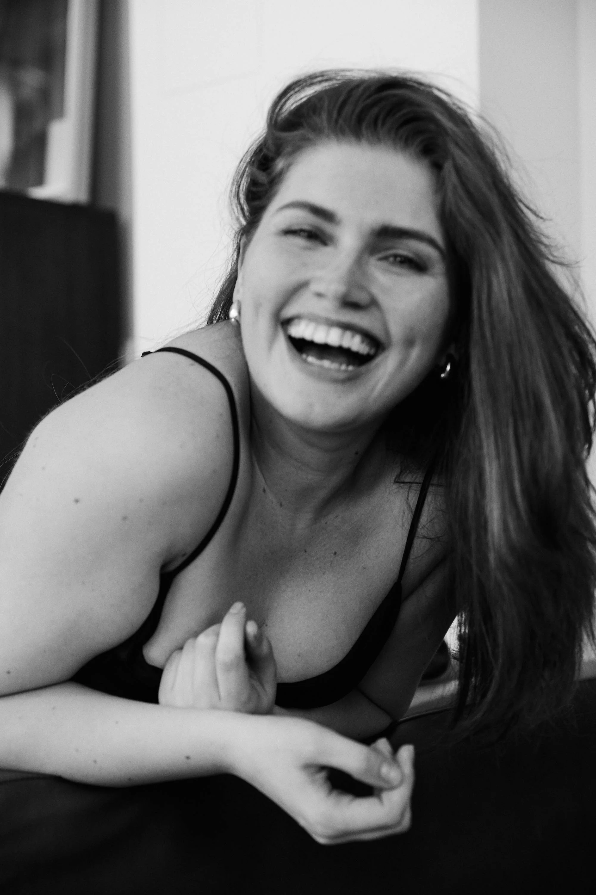 Black and white photo of girl smiling after somatic therapy