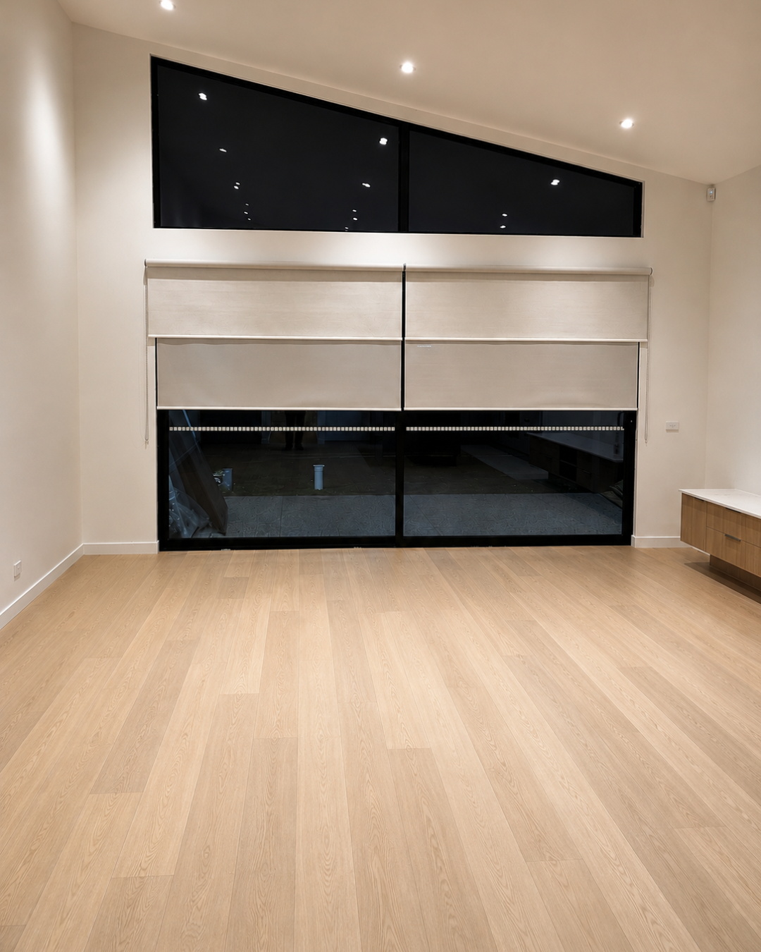 Living area with raked ceiling and high-level glazing — Chambers Road, Altona North.