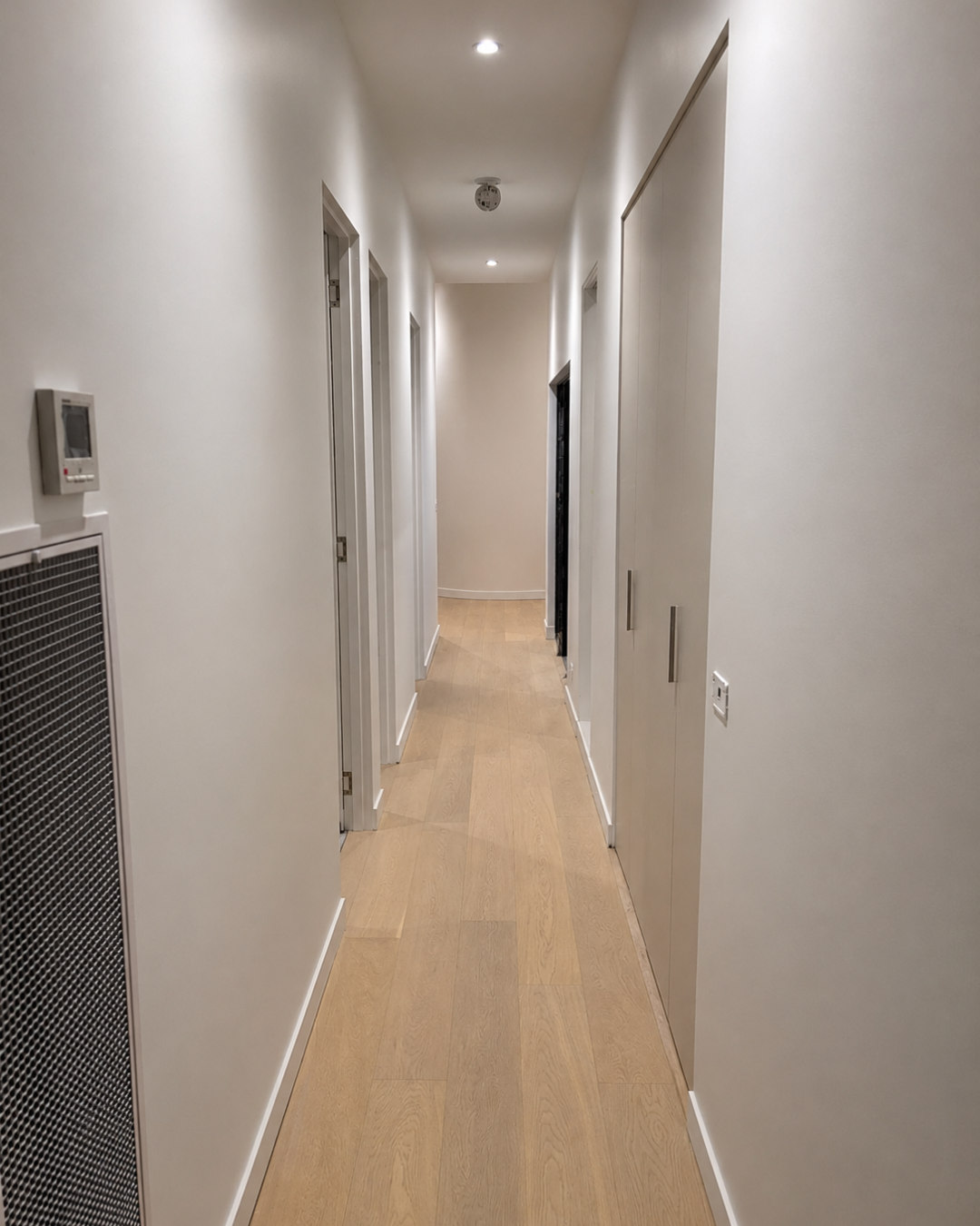 Hallway with clean door detailing and timber flooring — Chambers Road, Altona North.