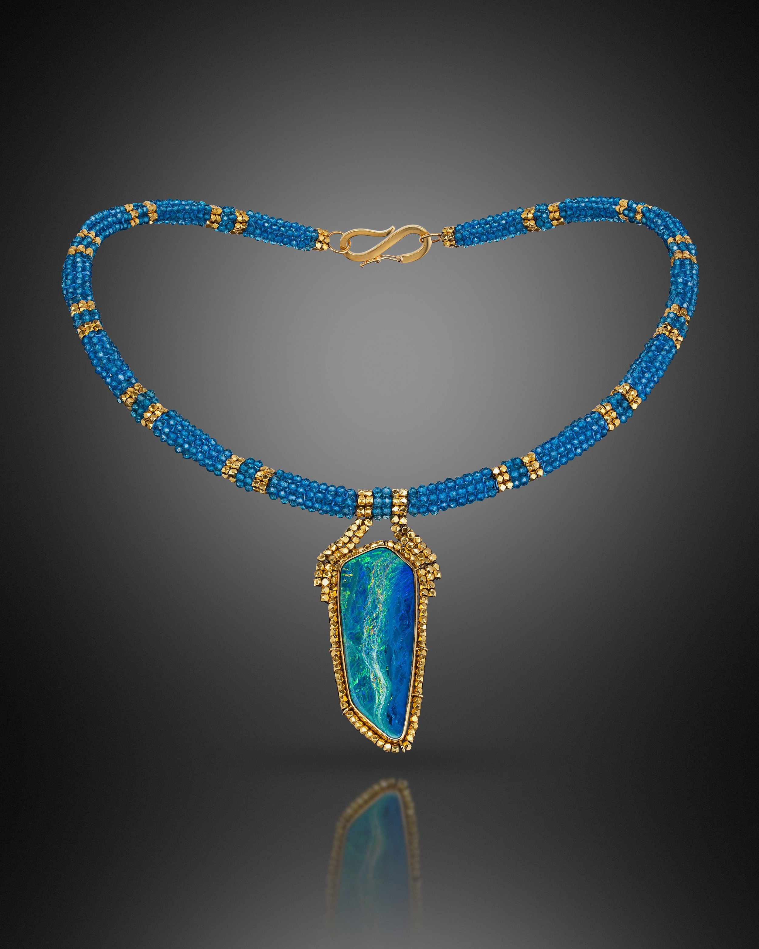 Seascape Choker.  Woven cord is made of blue topaz and 18k beads; pendant is hand fabricated of 18k gold, set with an Australian opal, surrounded by 18k gold beads.