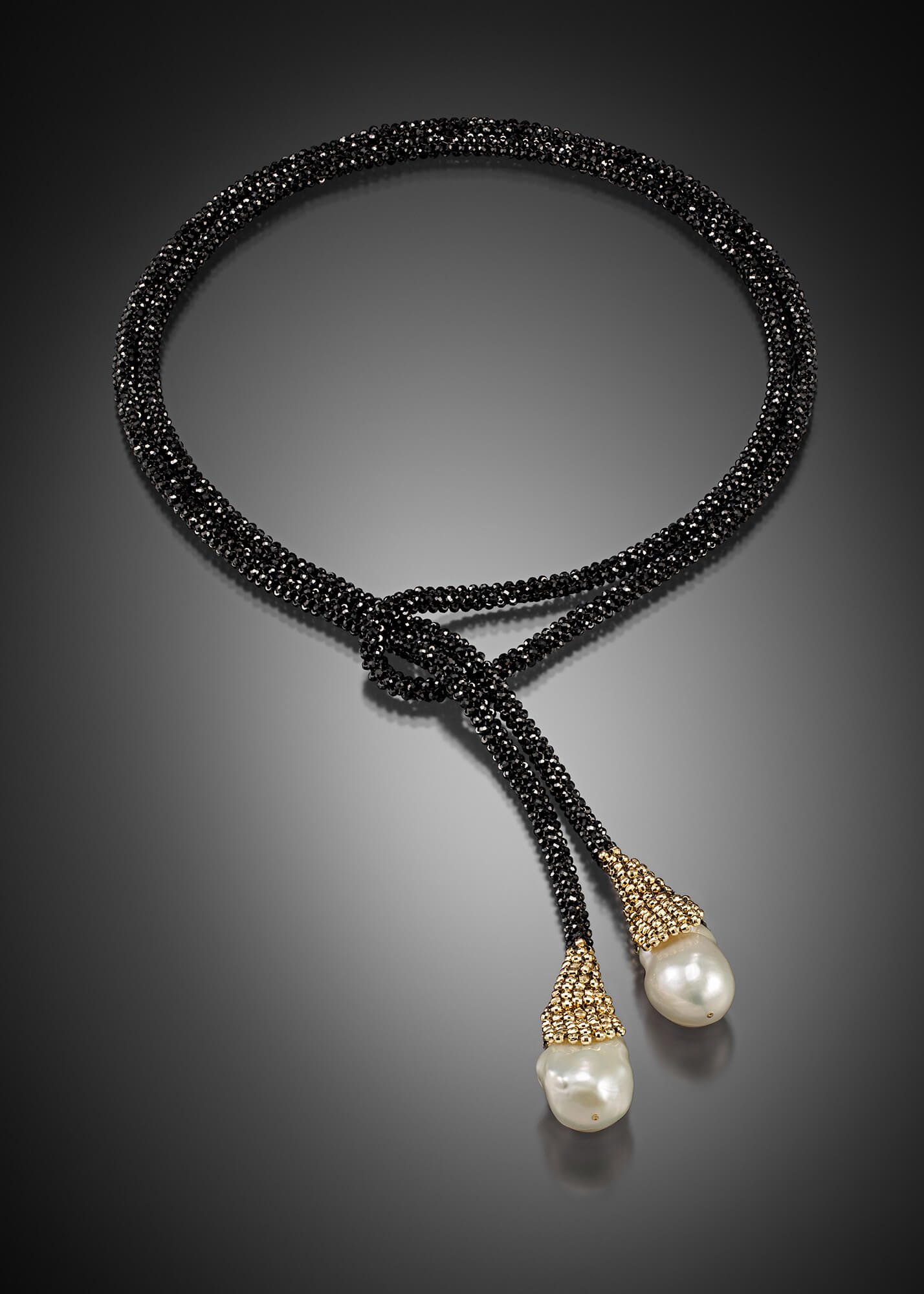 Pearl Lariat. This lariat's cord is woven of black spinel and 14k gold beads. It is finished with two baroque freshwater pearls.