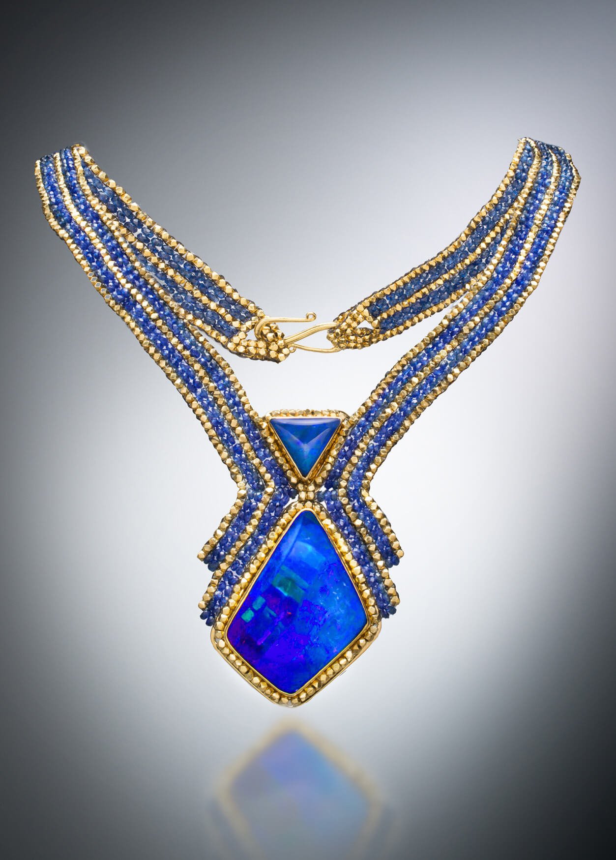 Opal and Sapphire Collar. This collar is hand woven of blue sapphire, and 18k gold beads. The two blue Australian boulder opals are set in hand fabricated 18k gold bezels.