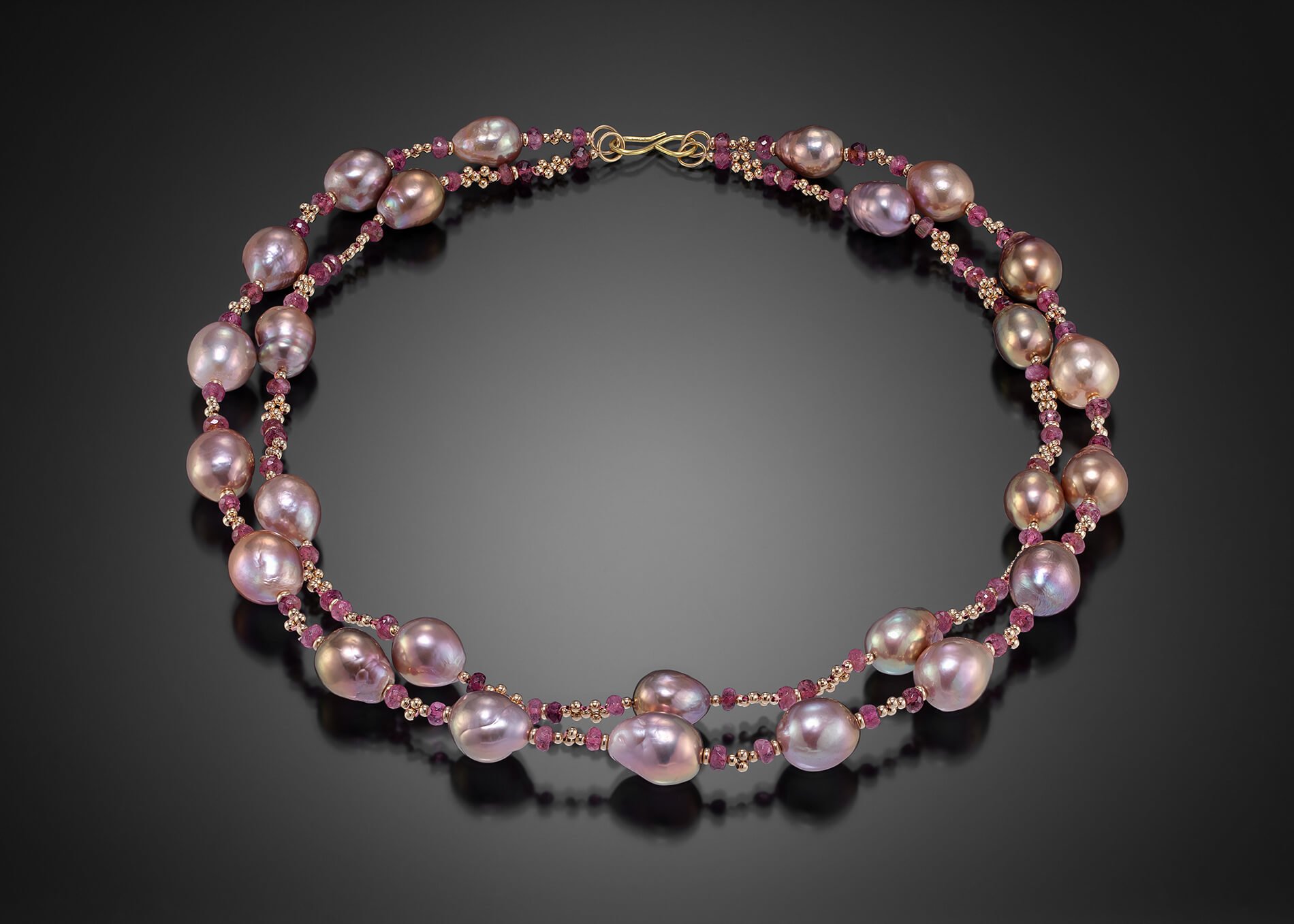 Mauve Pearl Necklace. This necklaces consists of two strands of natural mauve, baroque pearls, separated by woven gold and pink tourmaline beads.