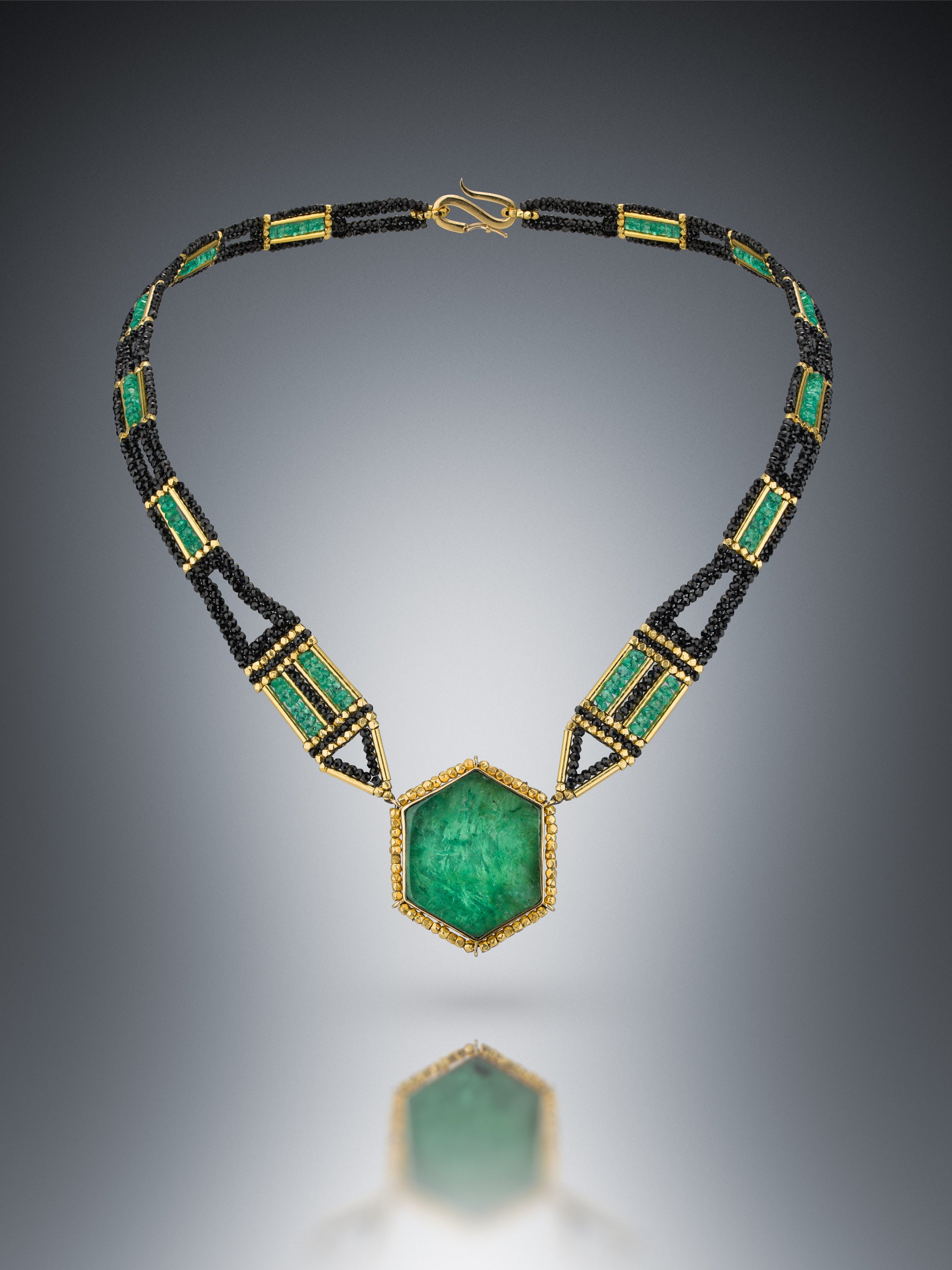 Emerald Slice.  This collar is hand woven of emerald, black spinel, and 18k gold beads. The bezel is fabricated with 18k gold and fine silver, set with an emerald slice.