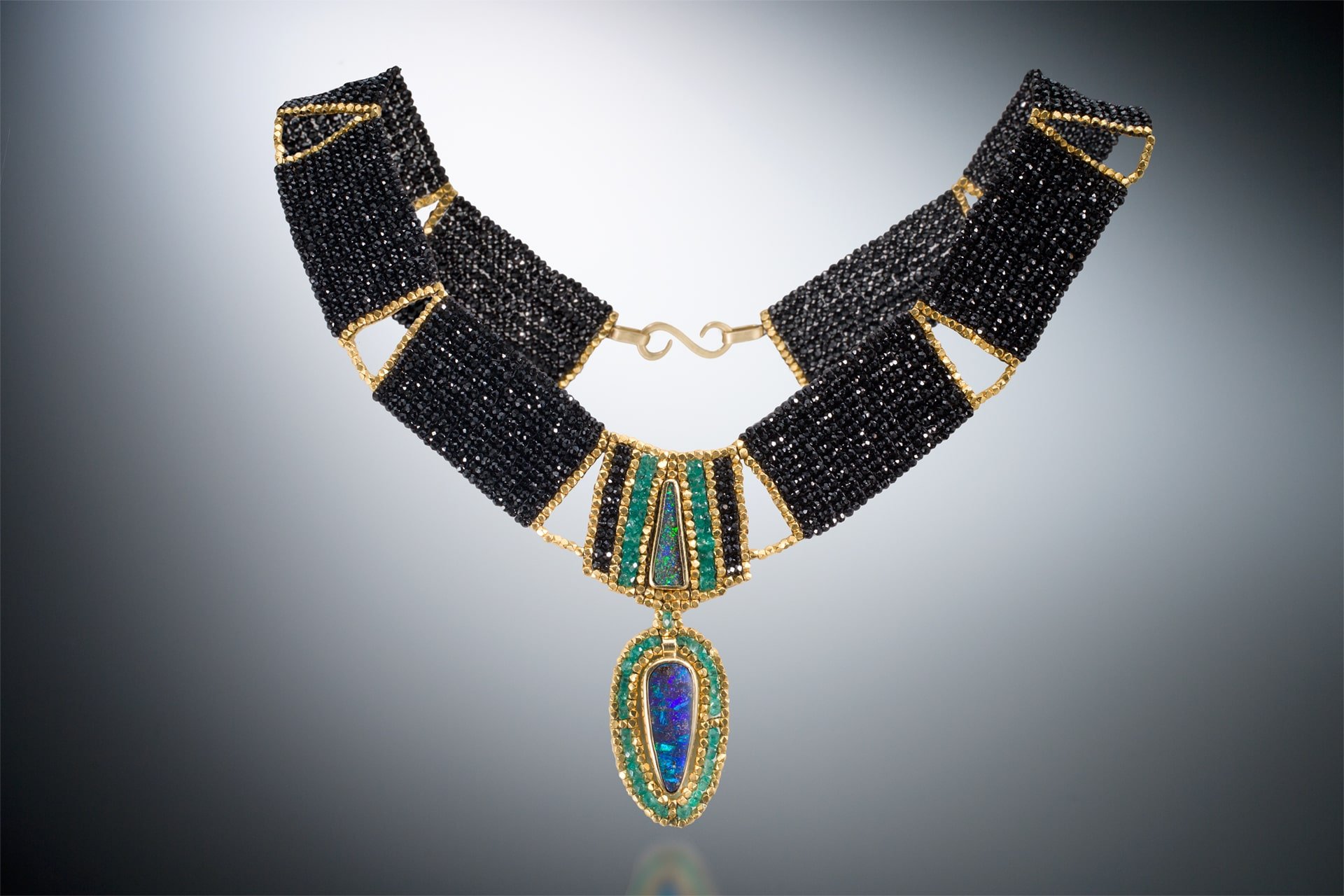 The Cleo Collar.  Hand woven out of black spinel, emerald, and 18k gold beads; hand fabricated bezels and clasp of 18k gold, and two Australian Boulder opals.