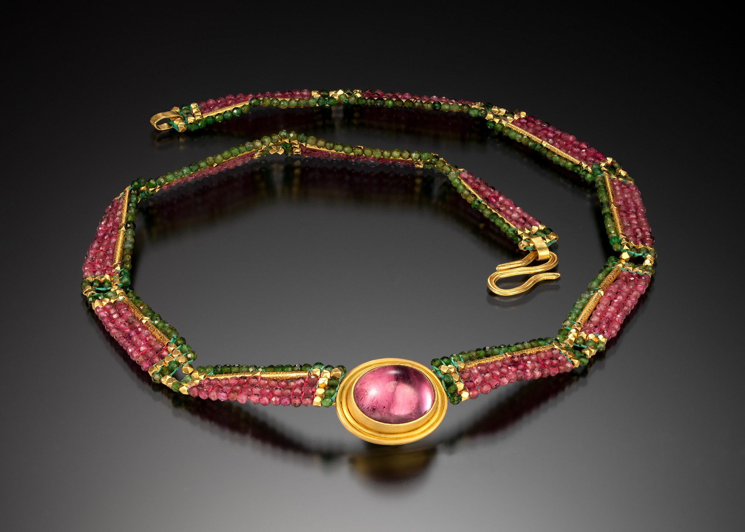 Watermelon Tourmaline. Hand woven of pink and green tourmaline beads, and combined with 18k gold tubes. The bezel and clasp are hand fabricated from 22K gold and set with a bright pink tourmaline.