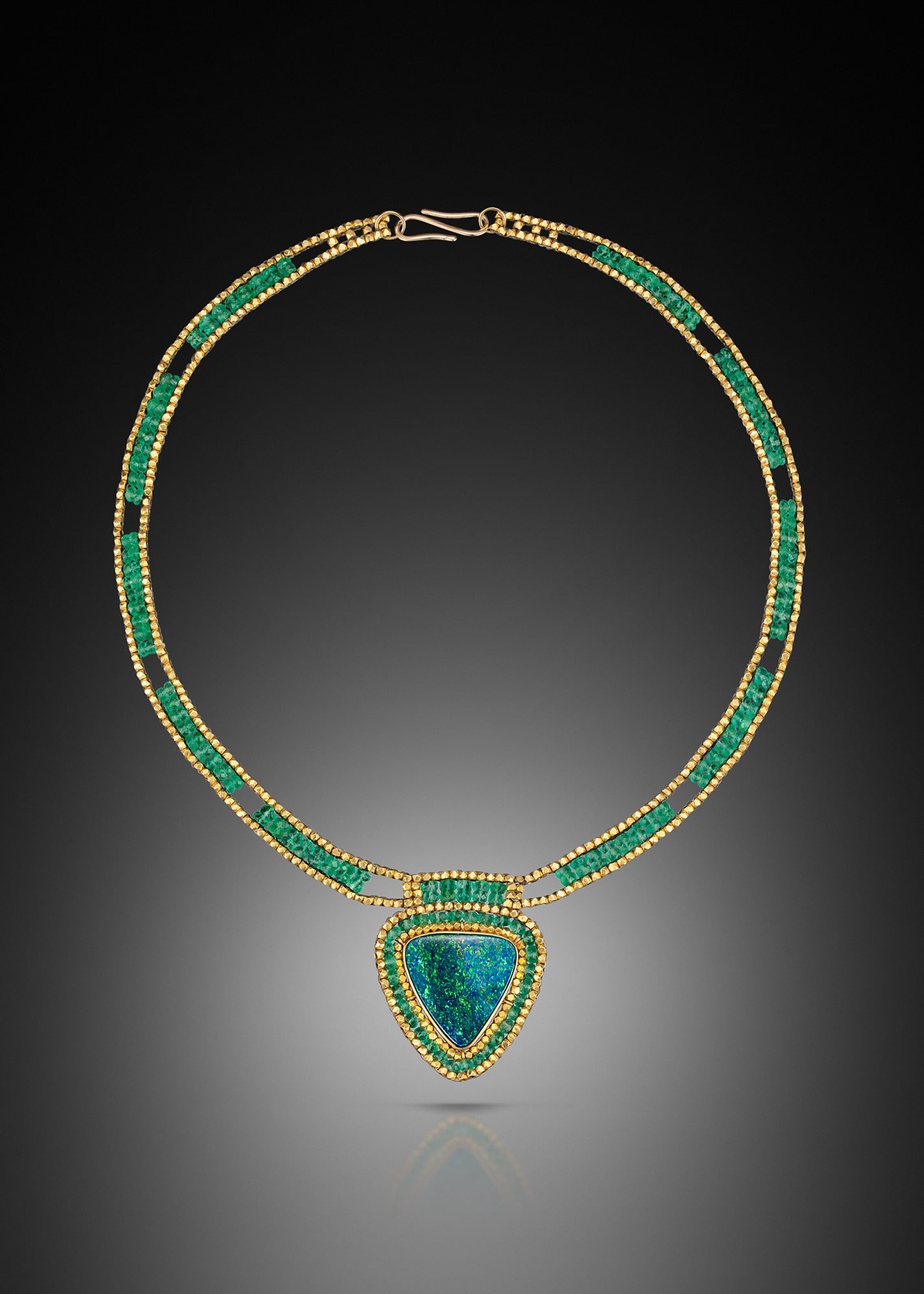 Opal and Emerald Collar. This hand woven necklace is made from emerald and 18k gold beads. The pendant is hand-fabricated from 18k gold, set with an Australian opal, surrounded by a woven frame.