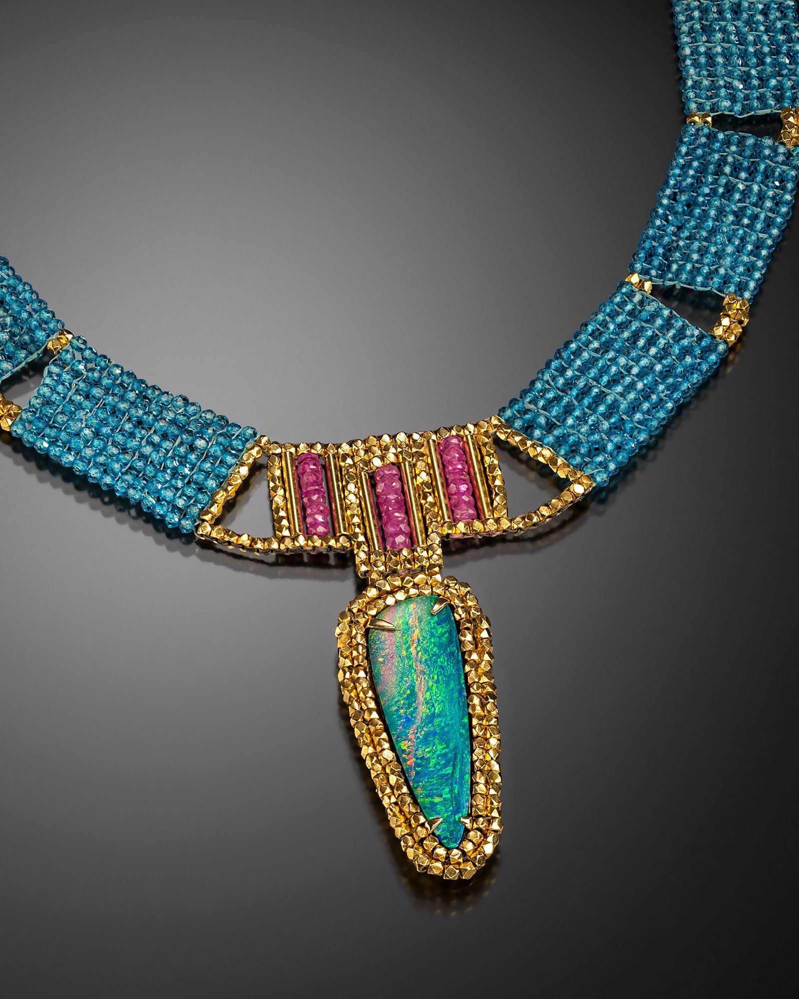 Opal and Pink Sapphire Collar.   Collar is hand woven of blue topaz, pink sapphire, and 18k gold beads; pendant is hand fabricated of 18k gold, set. with an Australian opal.