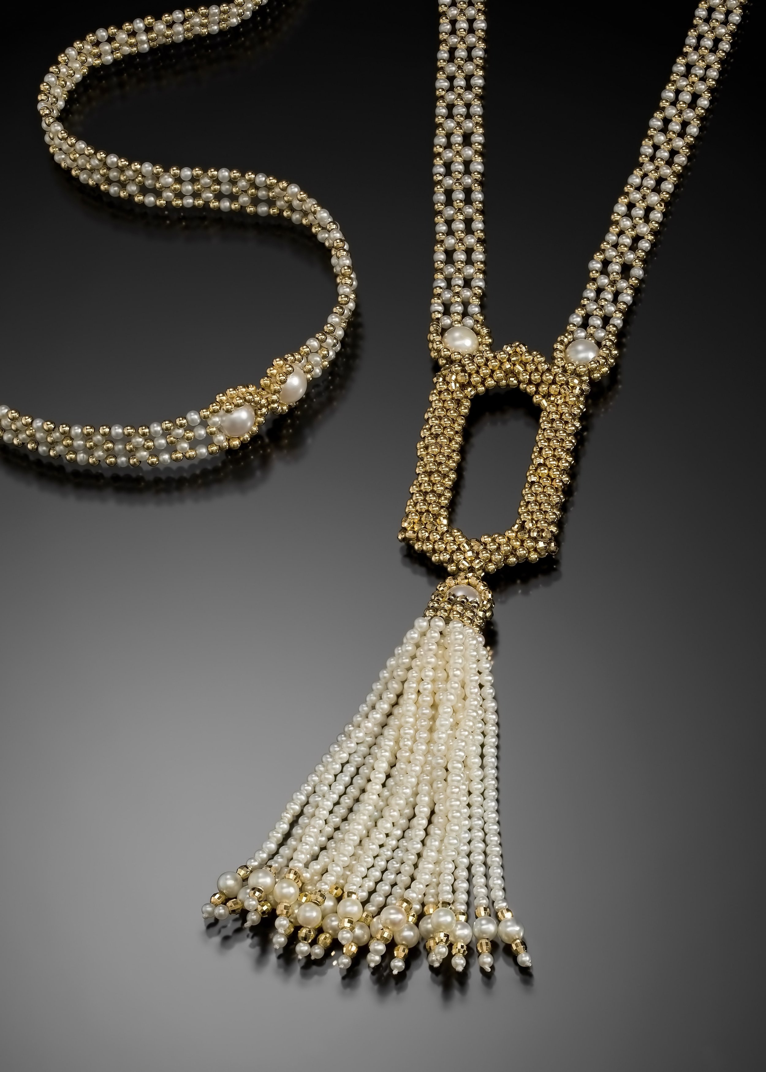 Pearl Sautoir.  The pieces is hand woven from tiny, freshwater, round pearls, and 14k gold beads.