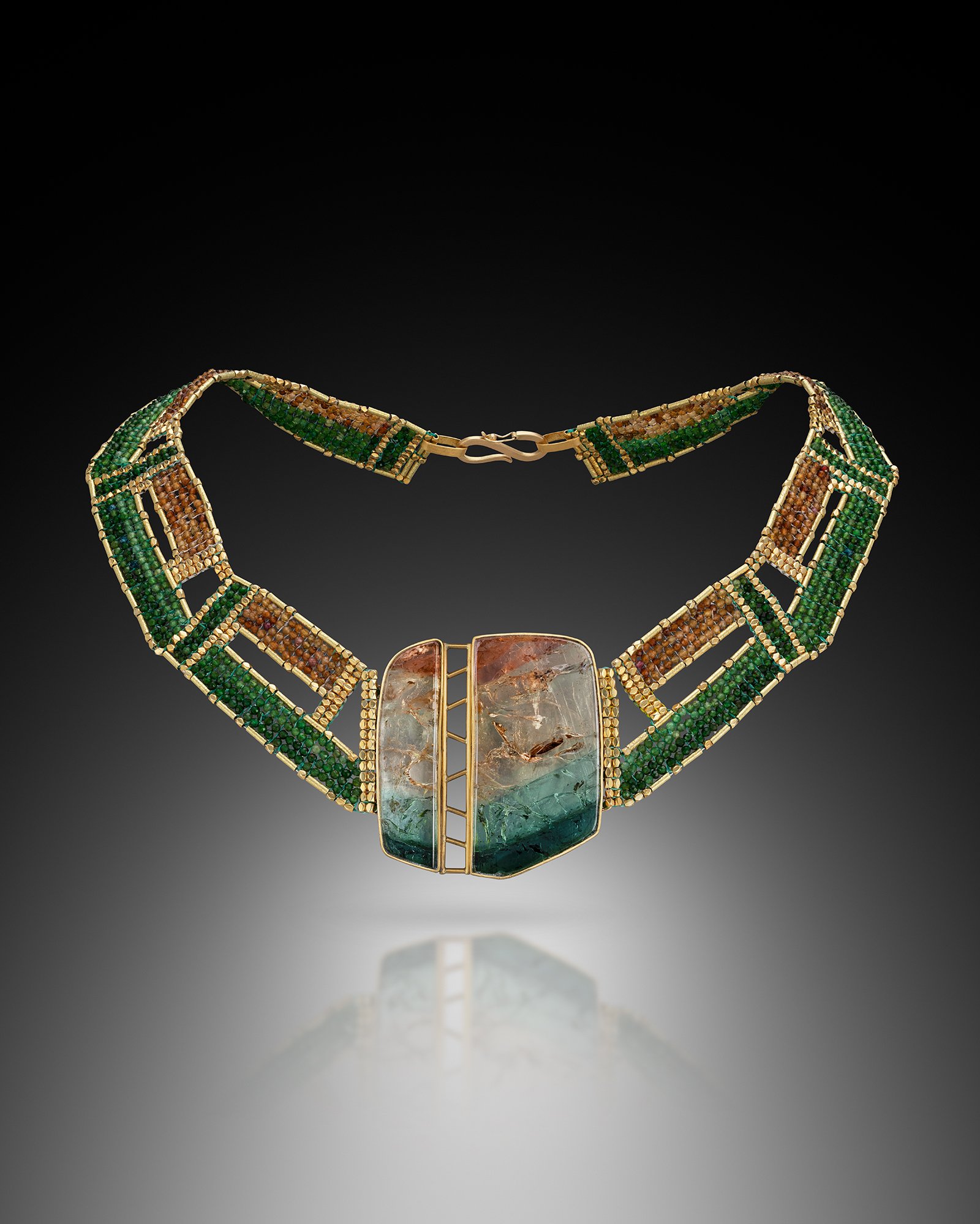 Landcape (2). This multicolor tourmaline collar is hand woven of tourmaline, and   20k gold beads.  The large, 2-part, tourmaline slice is set in a hand fabricated bezel of 22k and 18k gold.