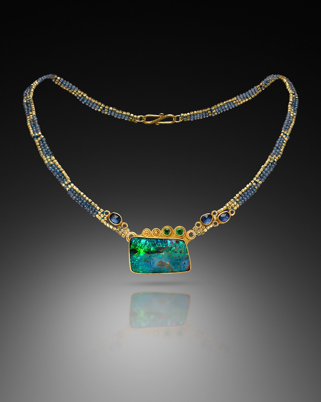Opal Neckpiece. Necklace, hand woven of tanzanite and 20k gold beads. Pendant, hand fabricated of 20k gold set with tsavorites, sapphires, and a boulder opal.