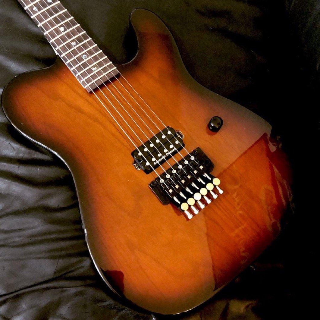 Electric guitar with sunburst finish on a dark background