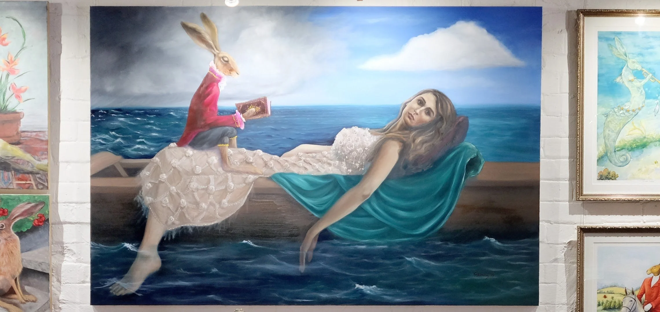 Surreal painting of a reclining woman in a boat with a rabbit dressed in red reading a book, set against a stormy sea and sky.