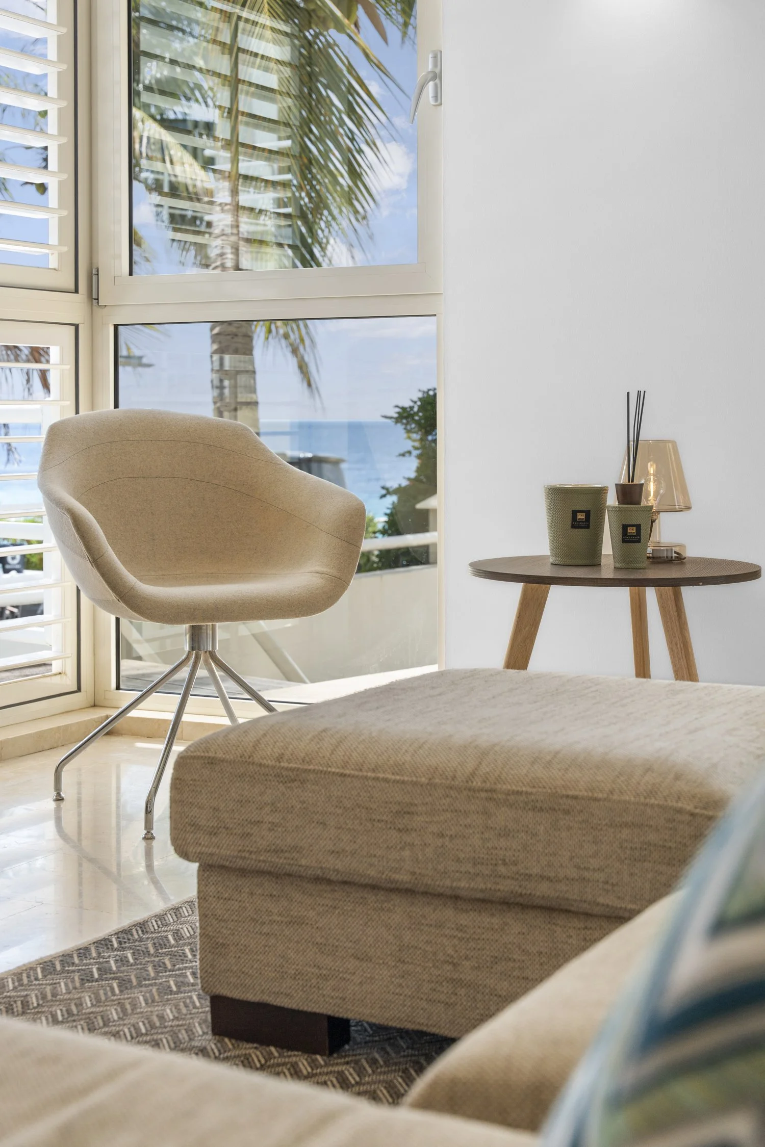 A chair and small coffee table in front of a window in a modern corner of the house