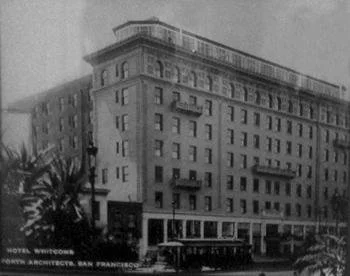 Black-and-white photograph of the Whitcomb Hotel, a multi-story building on a San Francisco street corner, around 1910