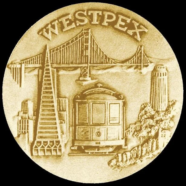 The 1983 WESTPEX exhibit medal showing four San Francisco landmarks: cable car, Golden Gate Bridge, Coit Tower, and Transamerica Pyramid
