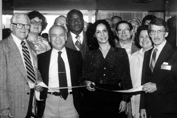 Black-and-white photograph of the 1980 WESTPEX ribbon-cutting ceremony with Lim P. Lee, Joseph Clary, and other volunteers and postal officials