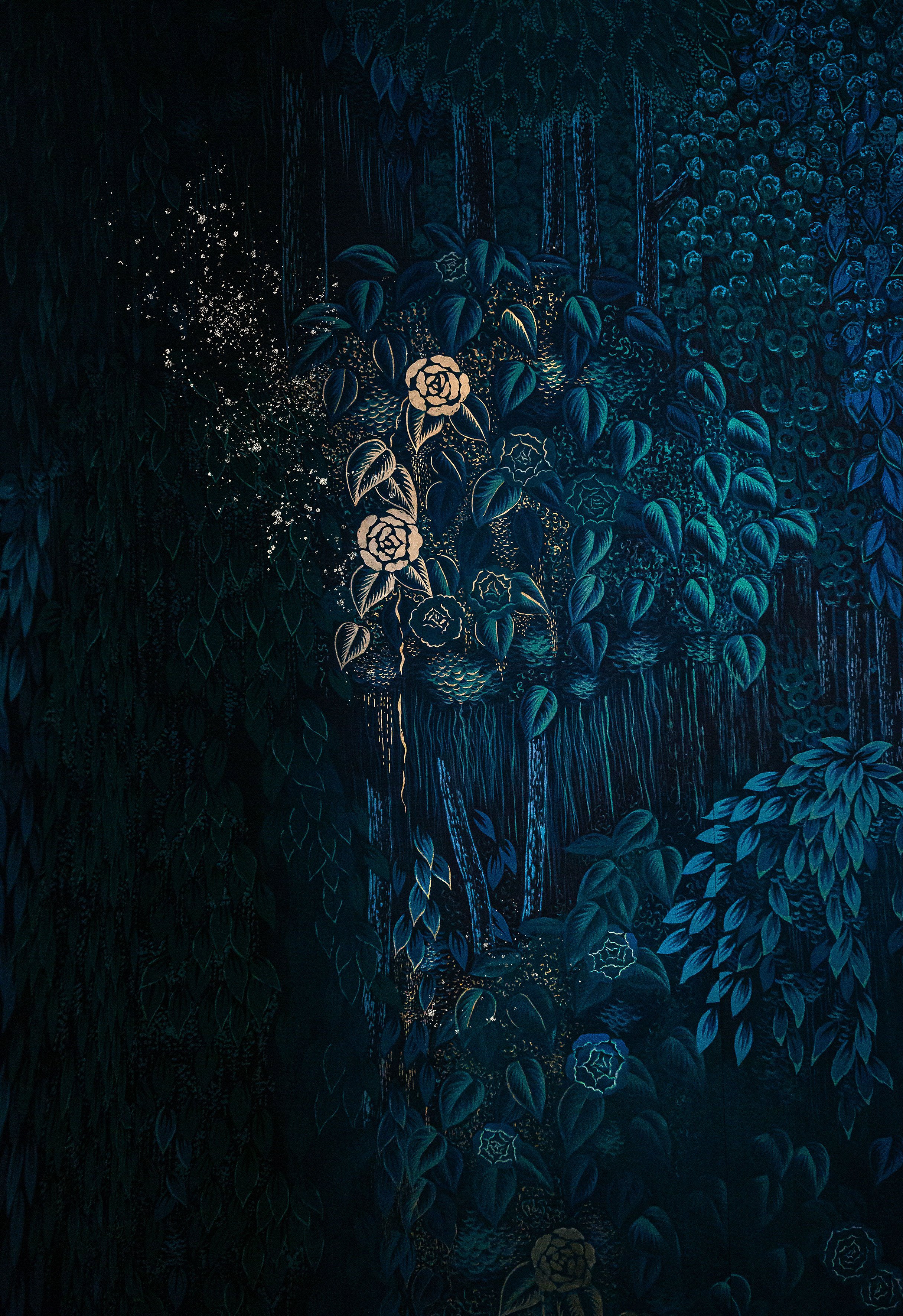Dark blue floral tapestry with intricate patterns of flowers, leaves, and vines, illuminated slightly to highlight the detailed design.