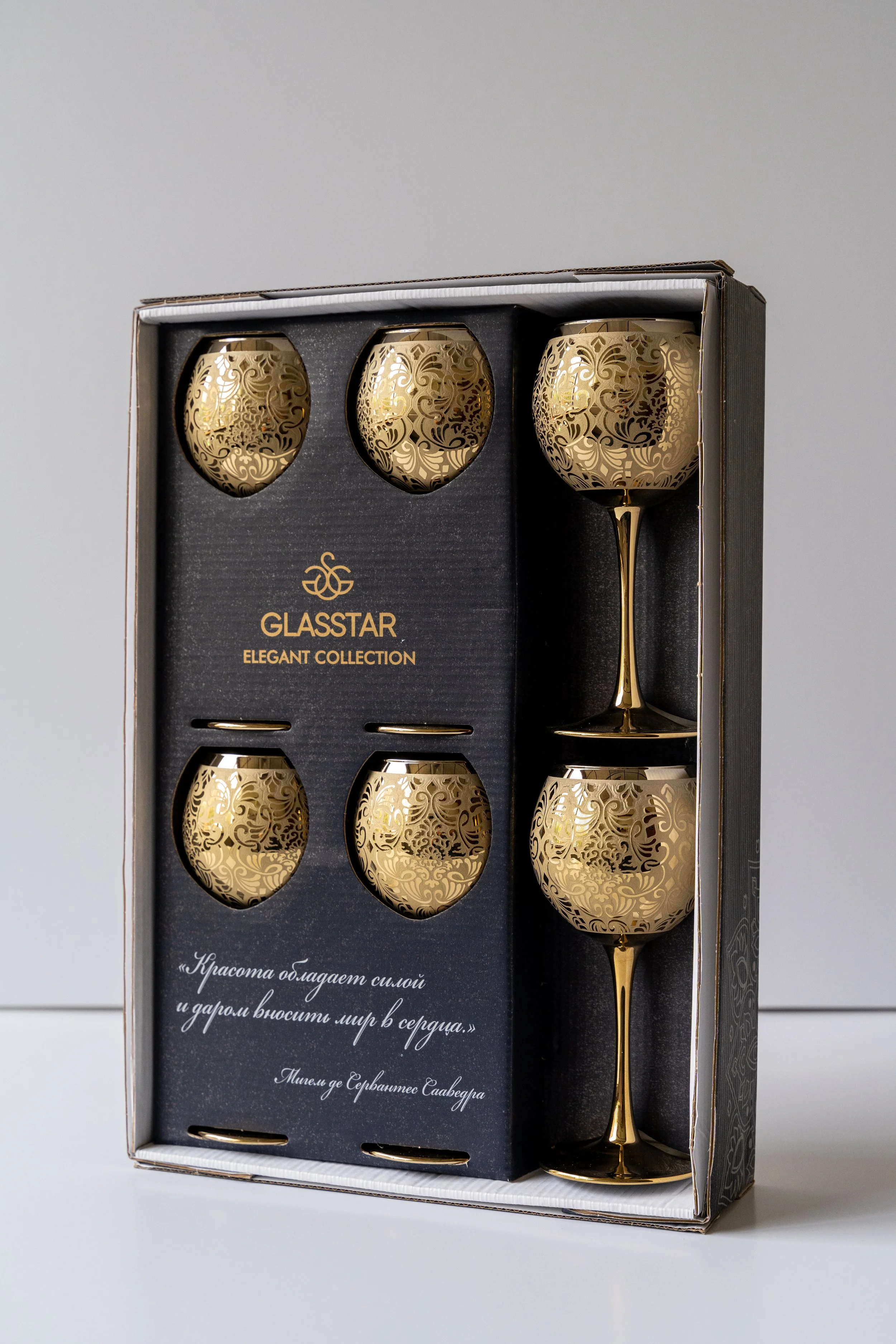 Set of six gold ornamental glasses in a black box with gold accents, labeled Glasstar Elegant Collection.