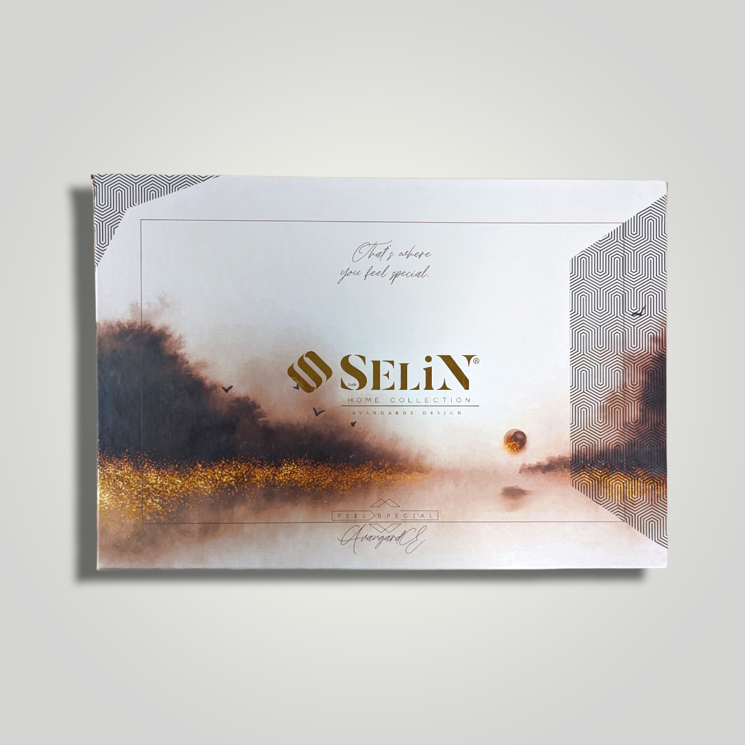Packaging box for Selix Home Collection with abstract landscape artwork and geometric patterns, featuring gold and dark accents on a light background.