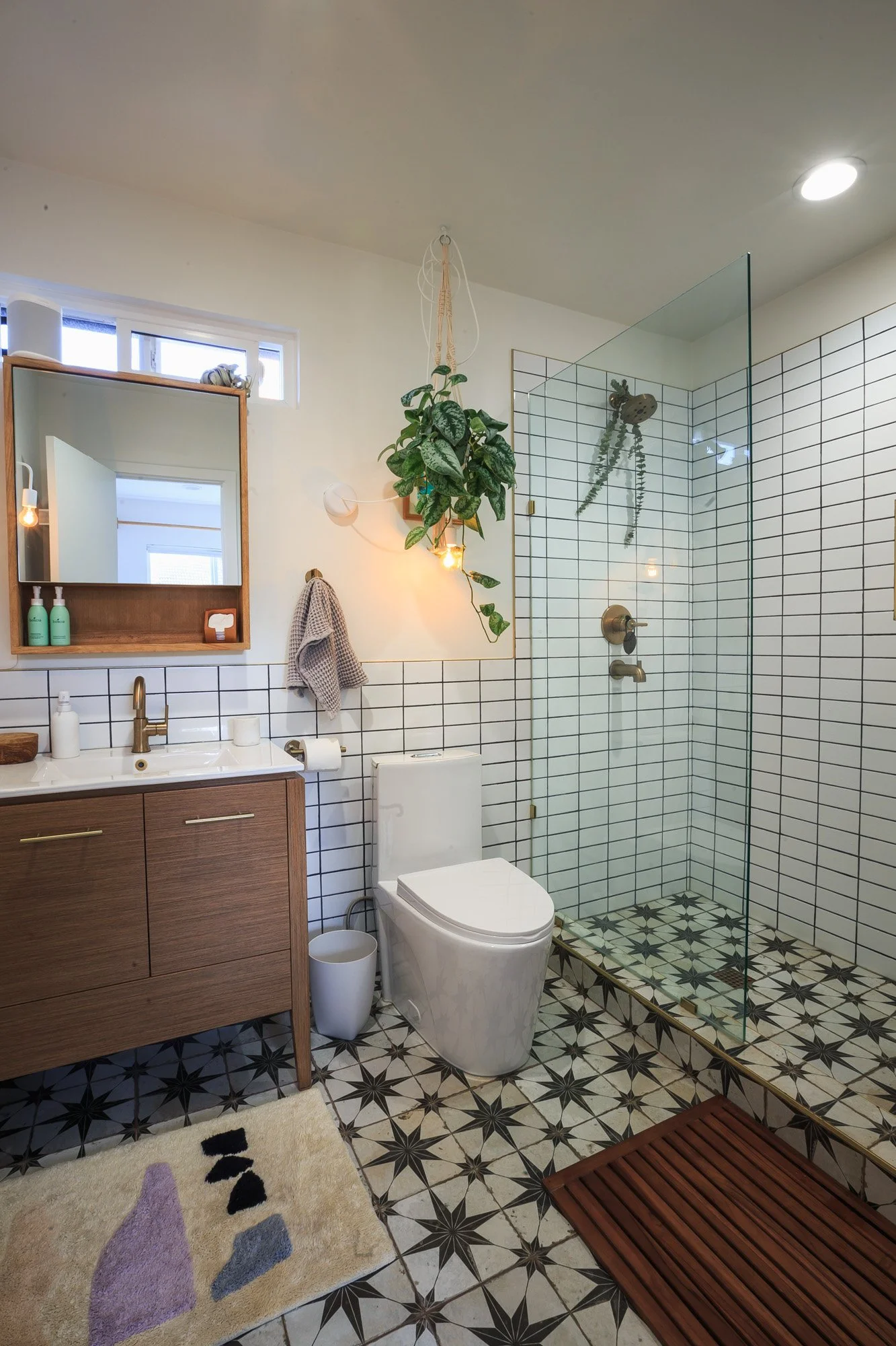 Bright tiled bathroom with plants in a Silver Lake Airbnb