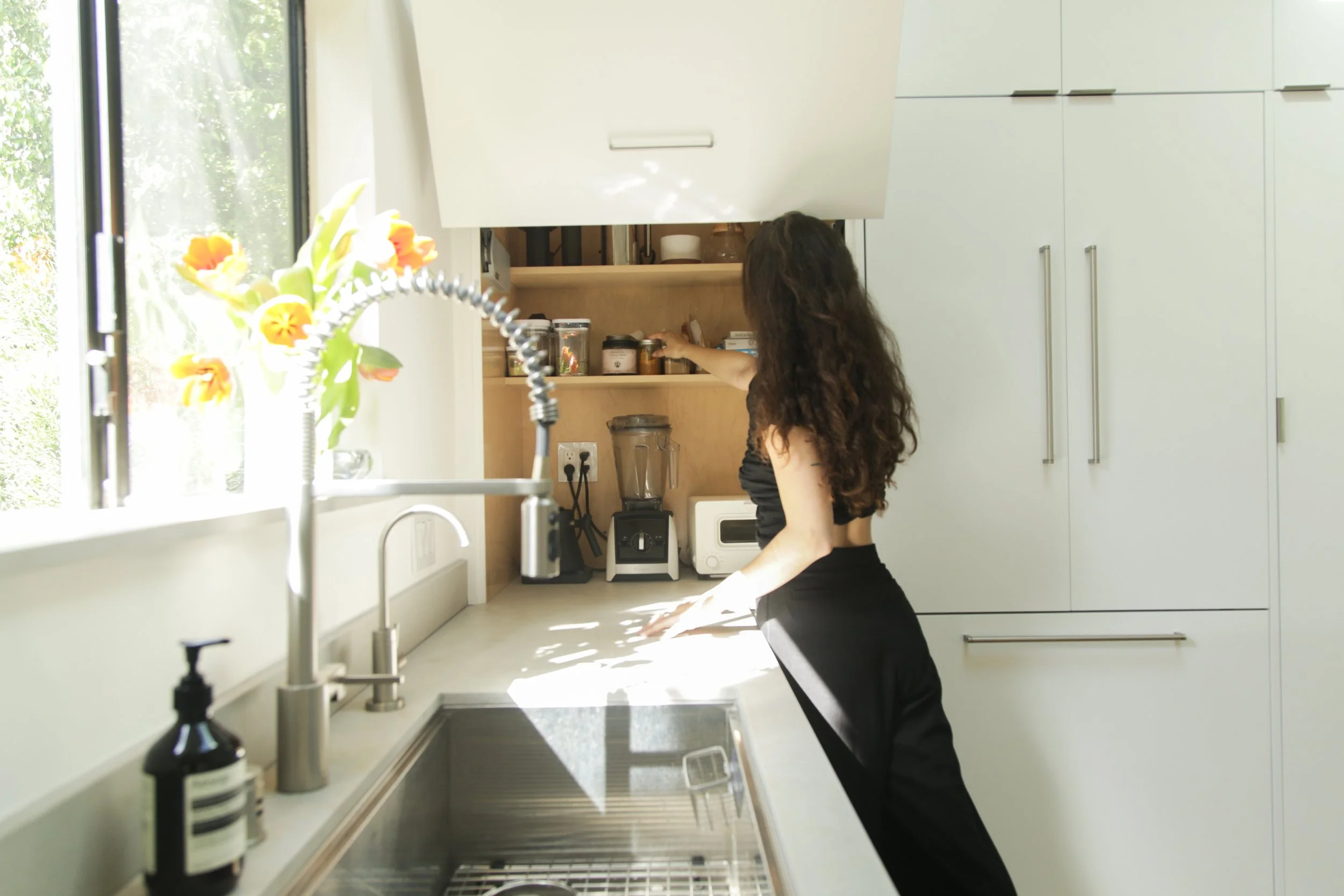 Abi Bock of Homing Interiors styling a Los Angeles Airbnb kitchen