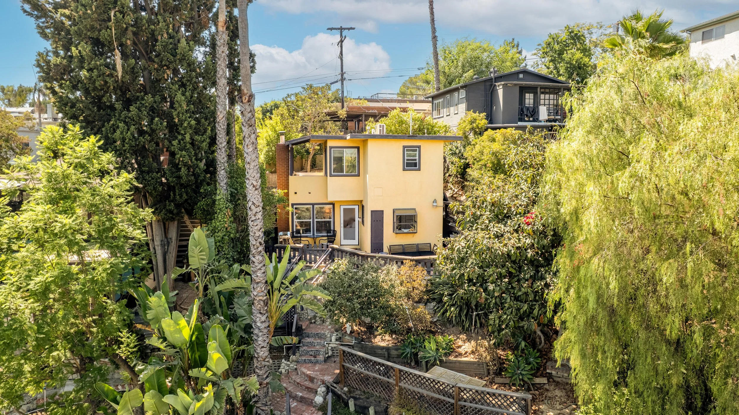 Fun yellow airbnb short term rental perched in the hills of mount washington, designed by Homing Interiors.