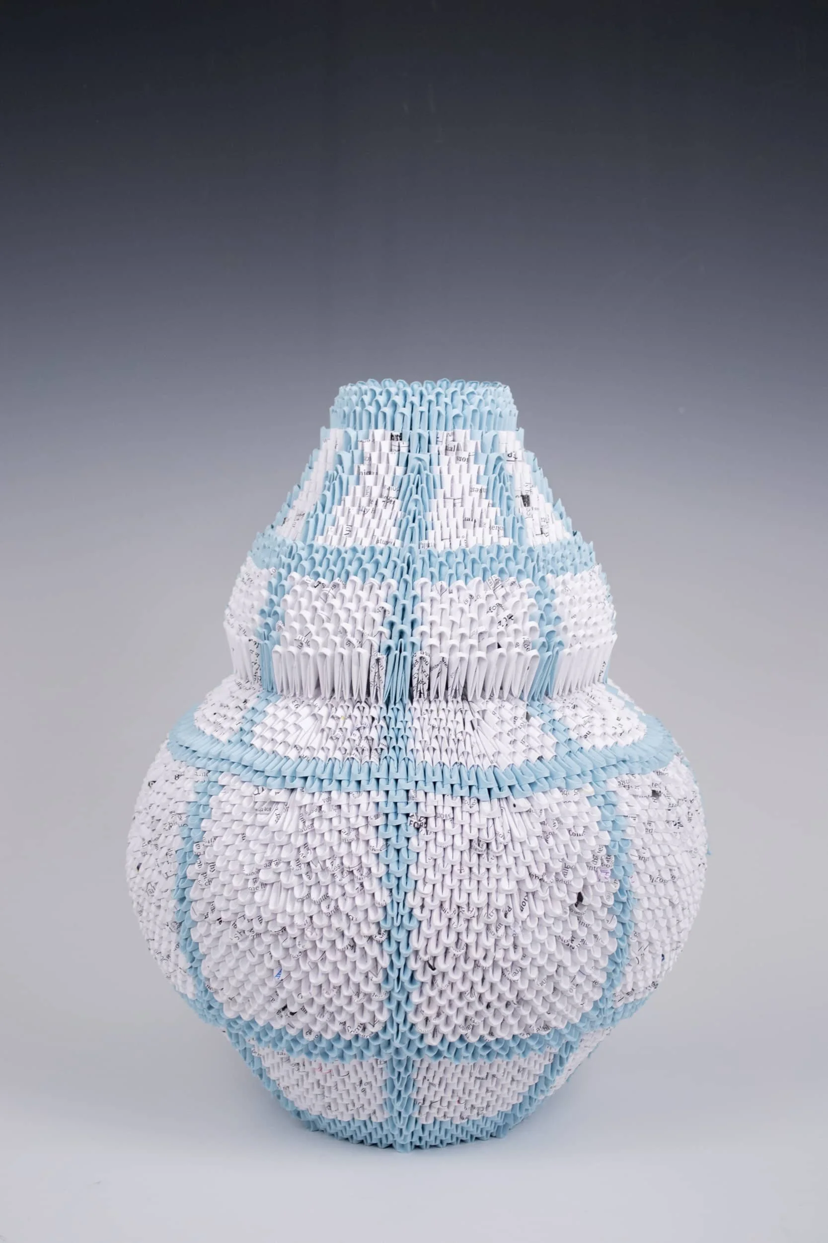 Title: Tulip Vase 5,952
Year: 2023
Medium: Paper
Dimensions:
11’’ x 11’’ x 14.5’’
Description of Fabrication:
For this vessel form, I drew inspiration from banded tulip seashells. I used to collect shells every time I went to the beach and the tuli