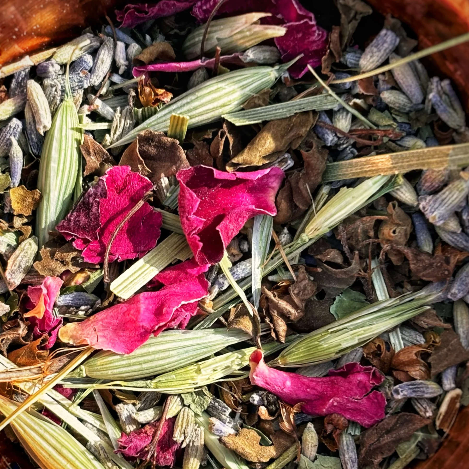 Close-up of dried flower petals, herbs, and plants such as rose petals, oat tops, lavender.