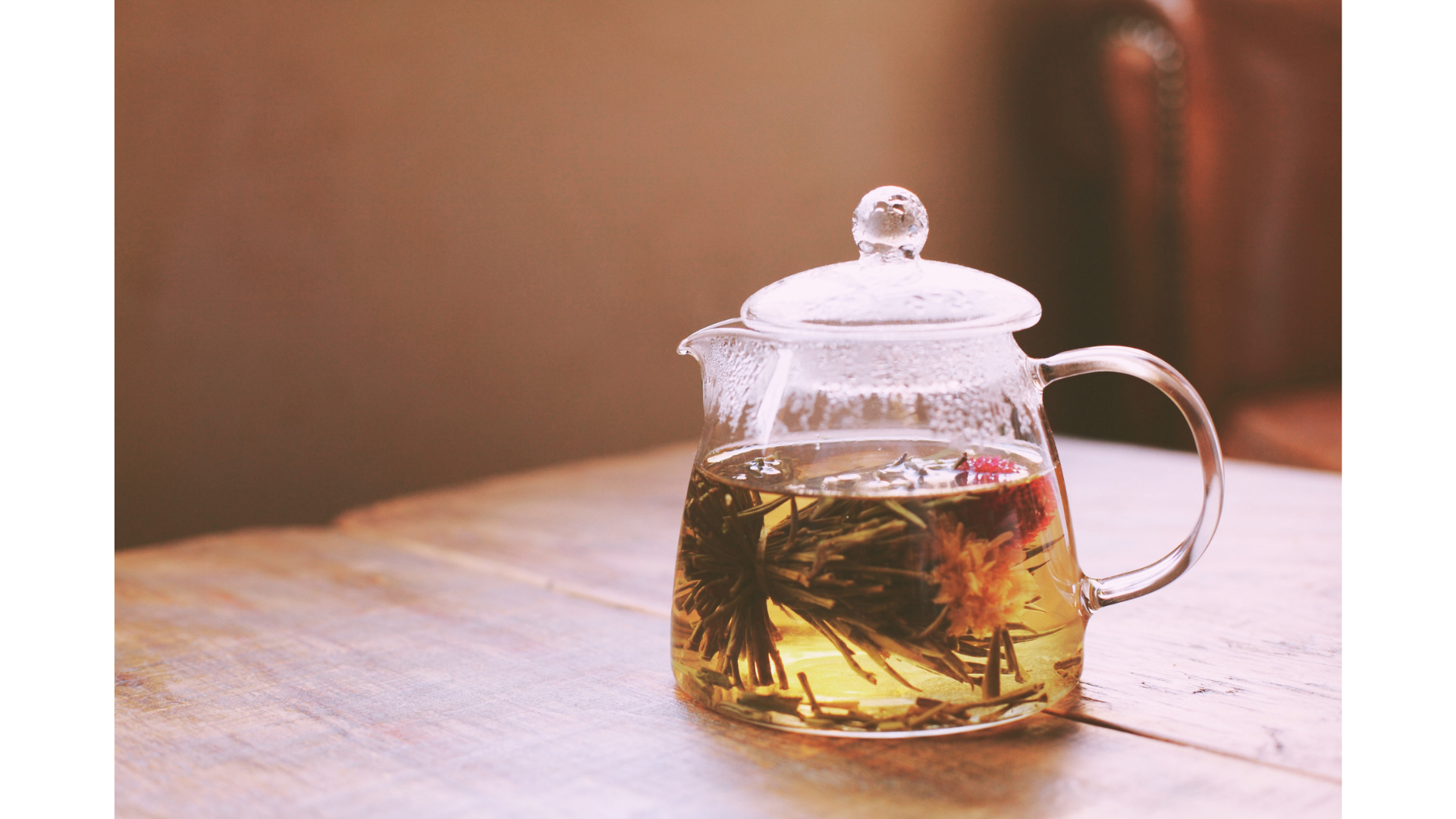 Blooming tea ball steeping in a glass tea pot.