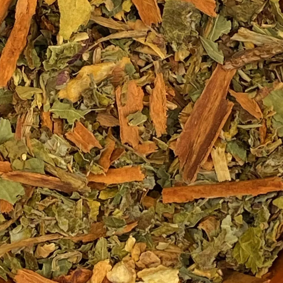 Close-up of dried herbs and spices, including nettle, cinnamon sticks, ginger and raspberry leaf.