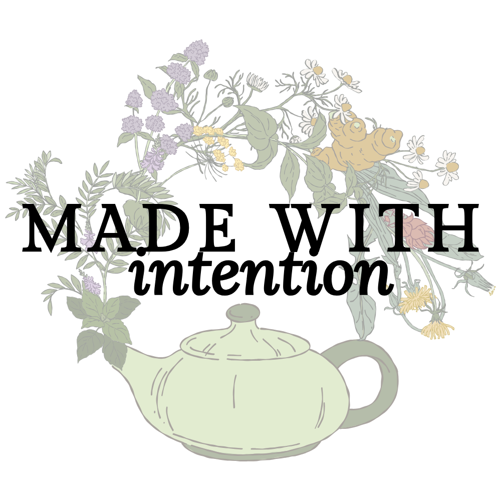 A green teapot with a spout and handle, filled with a bouquet of various flowers including daisies, ginger, and purple blossoms made with intention.