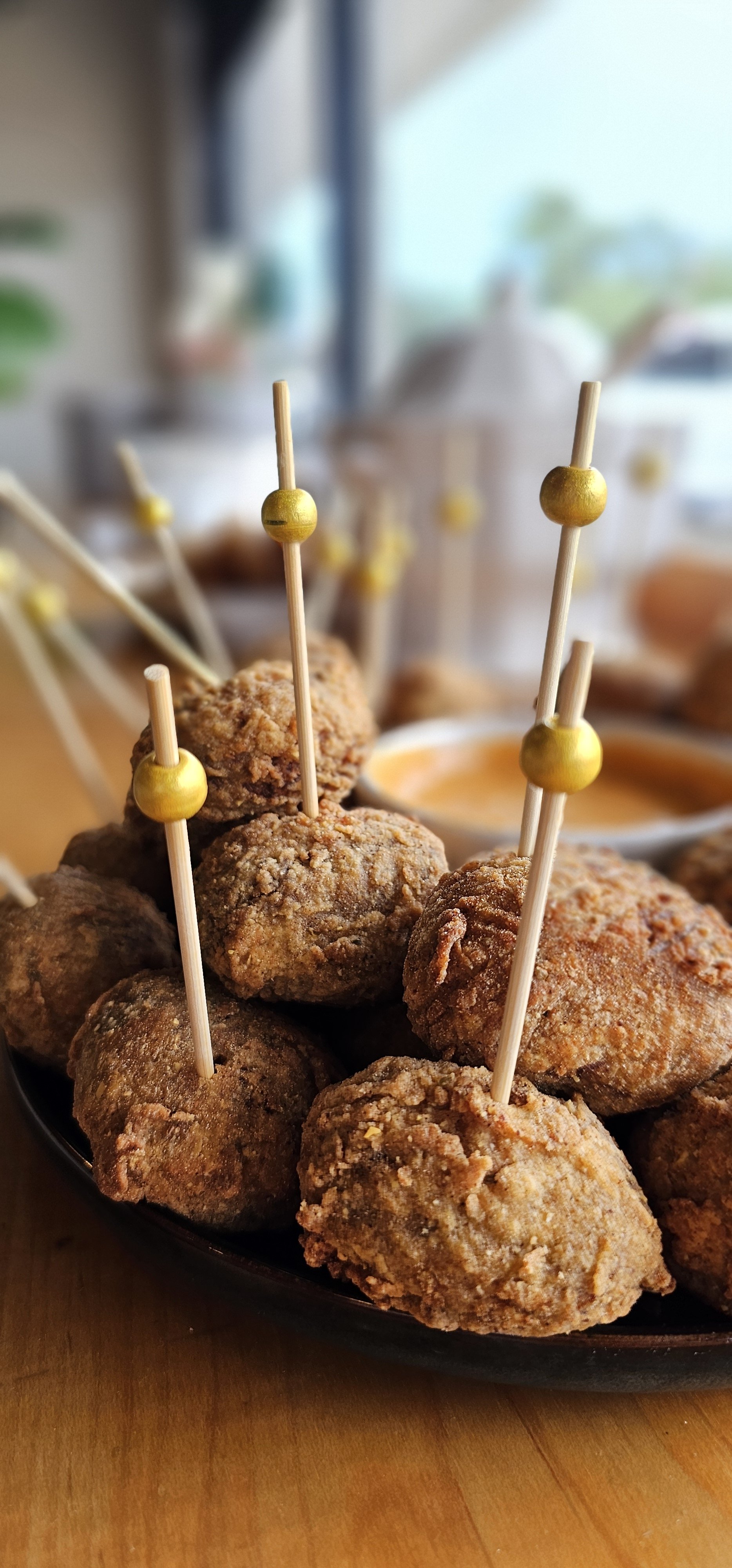 Fried boudin balls on gold party picks with remoulade, a Louisiana appetizer for events at JED’s Local
