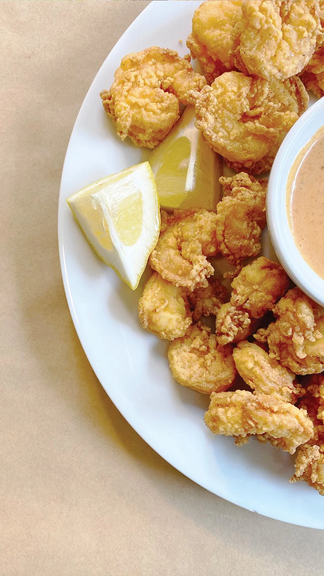 Fried shrimp platter with lemon wedges and house-made sauce for events