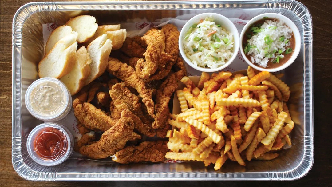Large catering tray with fried chicken tenders and sides prepared for LSU game day catering
