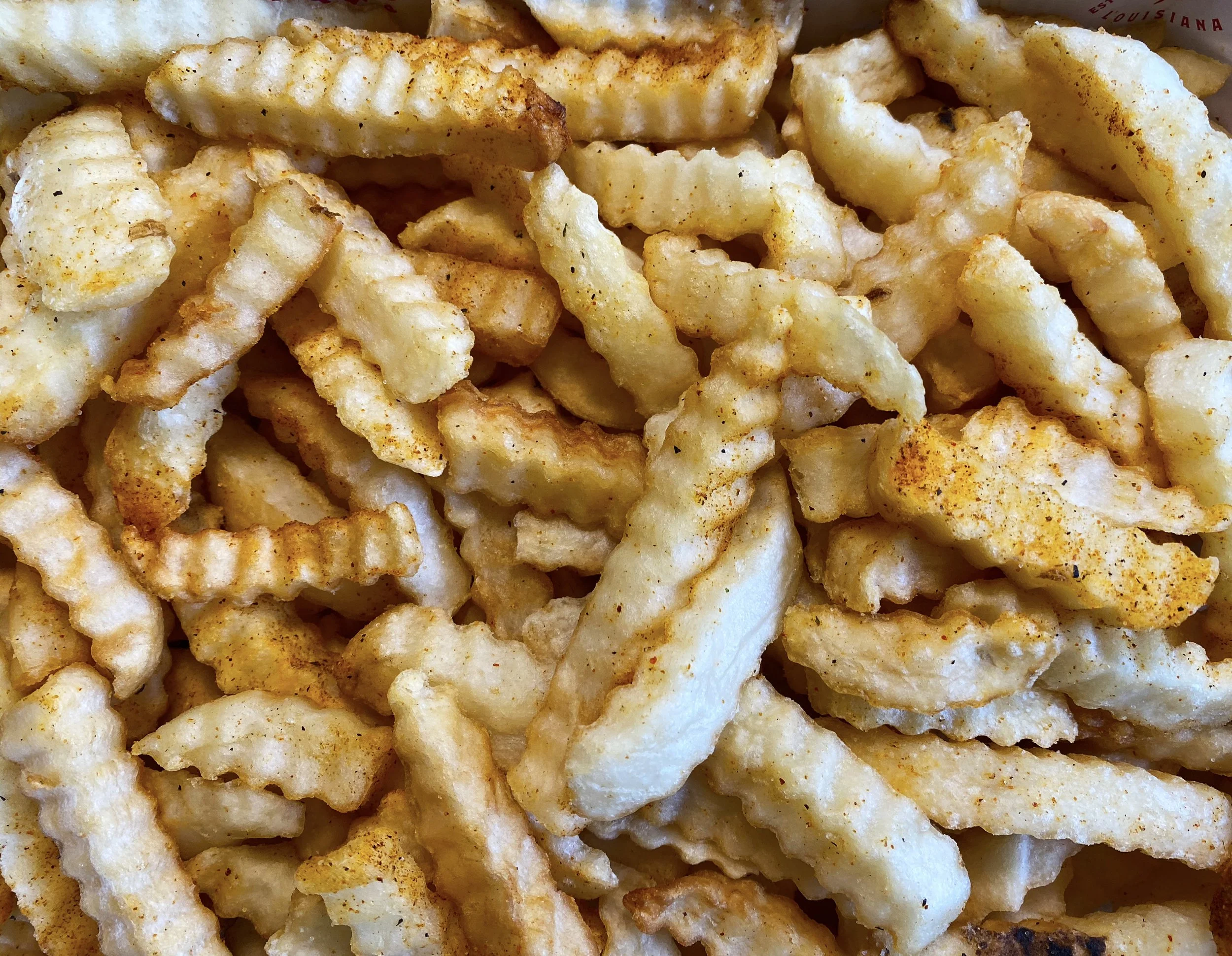 Seasoned crinkle-cut fries served as a catering side at Jed’s Local