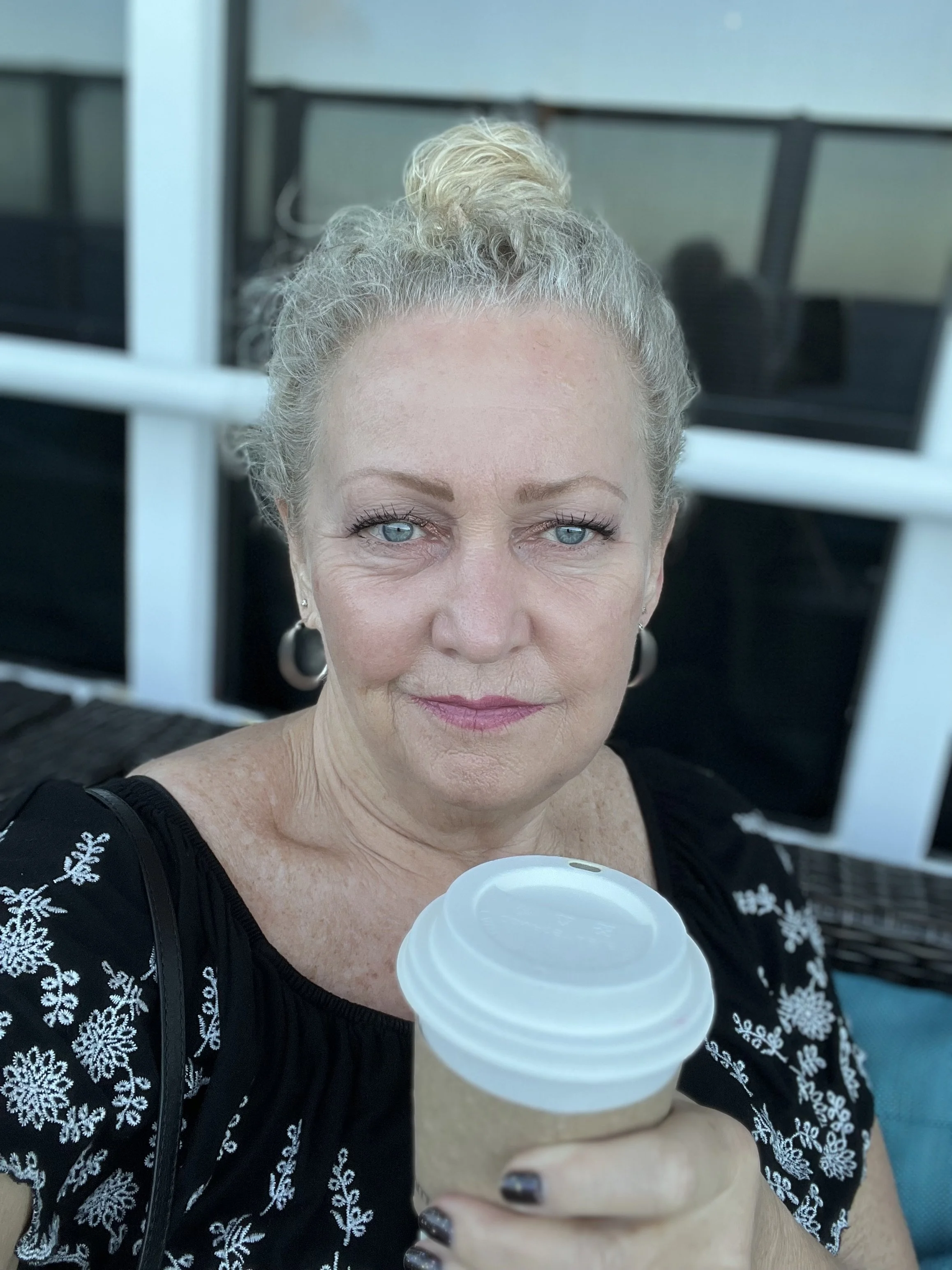 Delee D'Arcy having coffee, reflecting on communication and conversations in relationships.