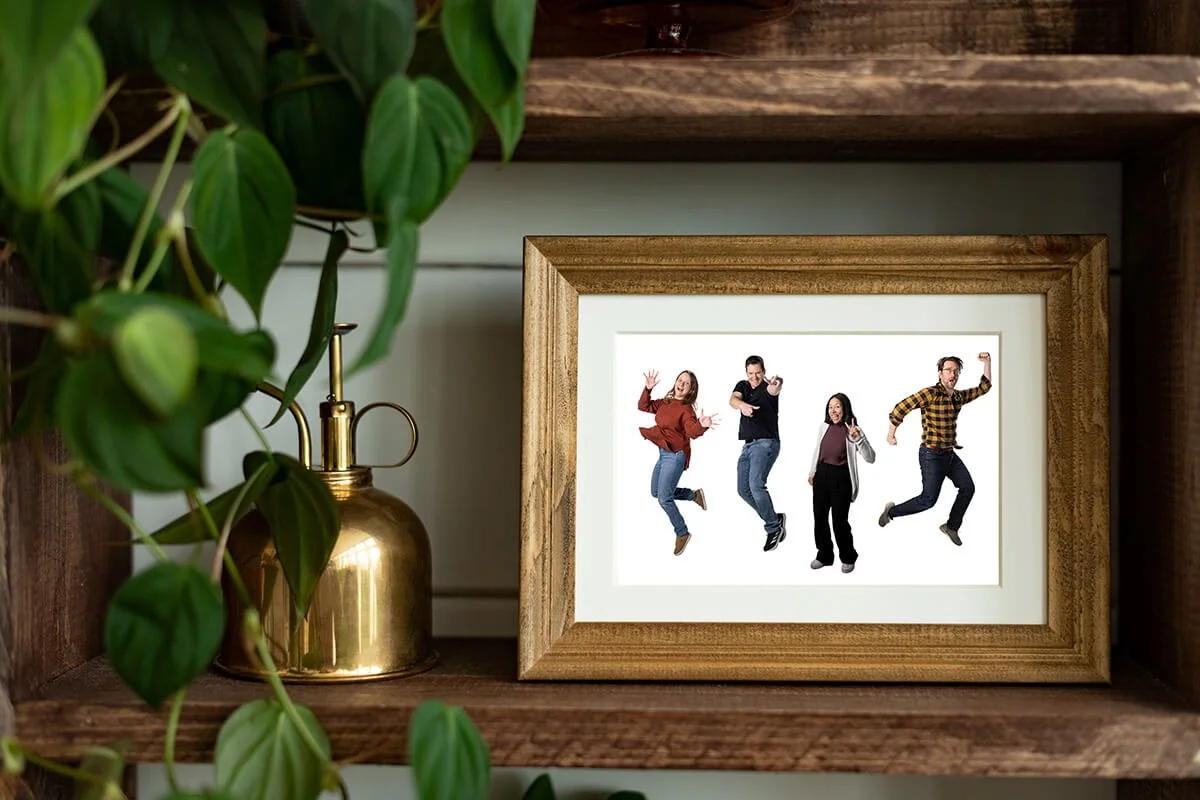 Picture frame with an image of the Landing Studio team inside sitting on a shelf.